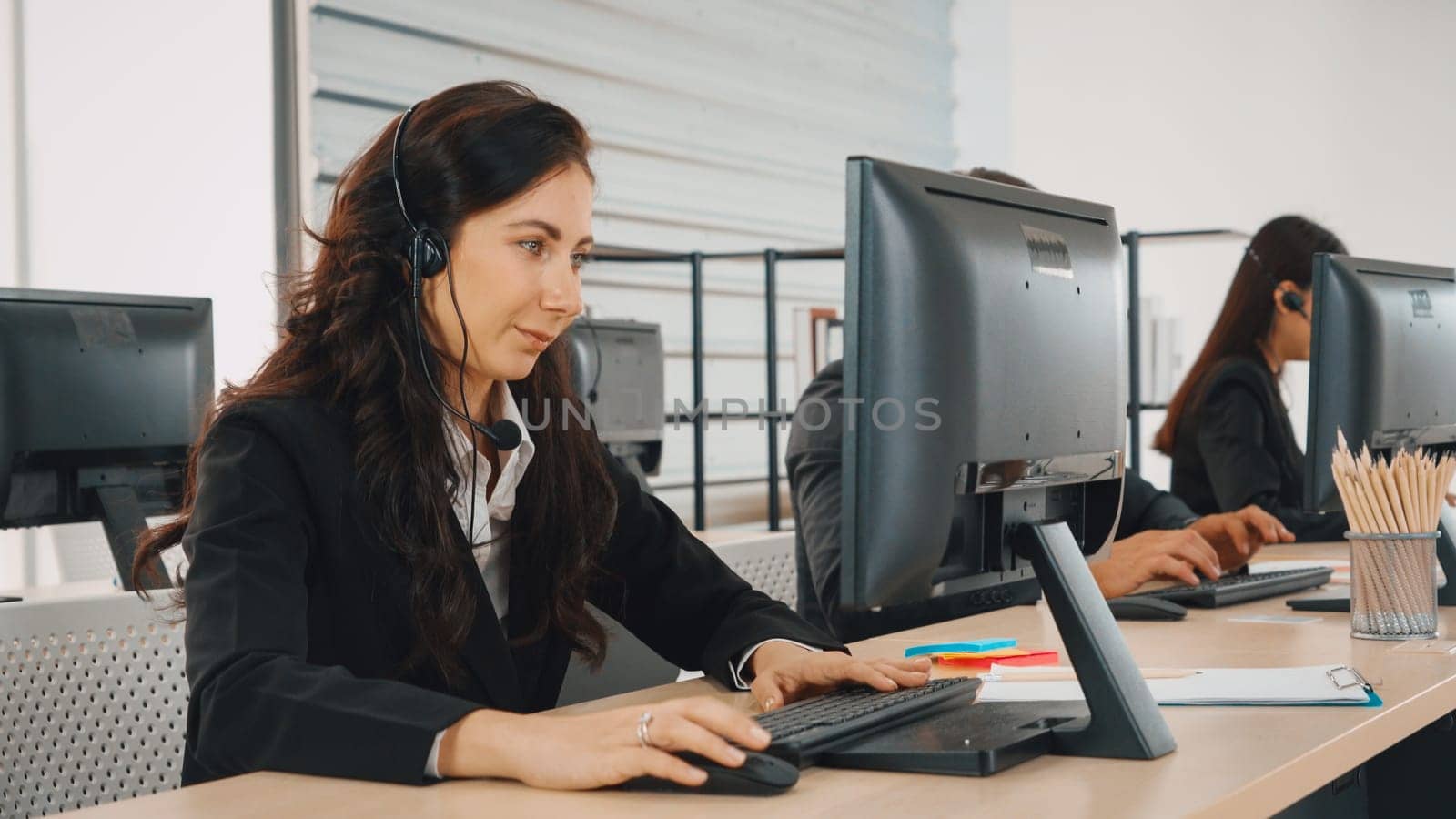 Business people wearing headset working in office Jivy by biancoblue