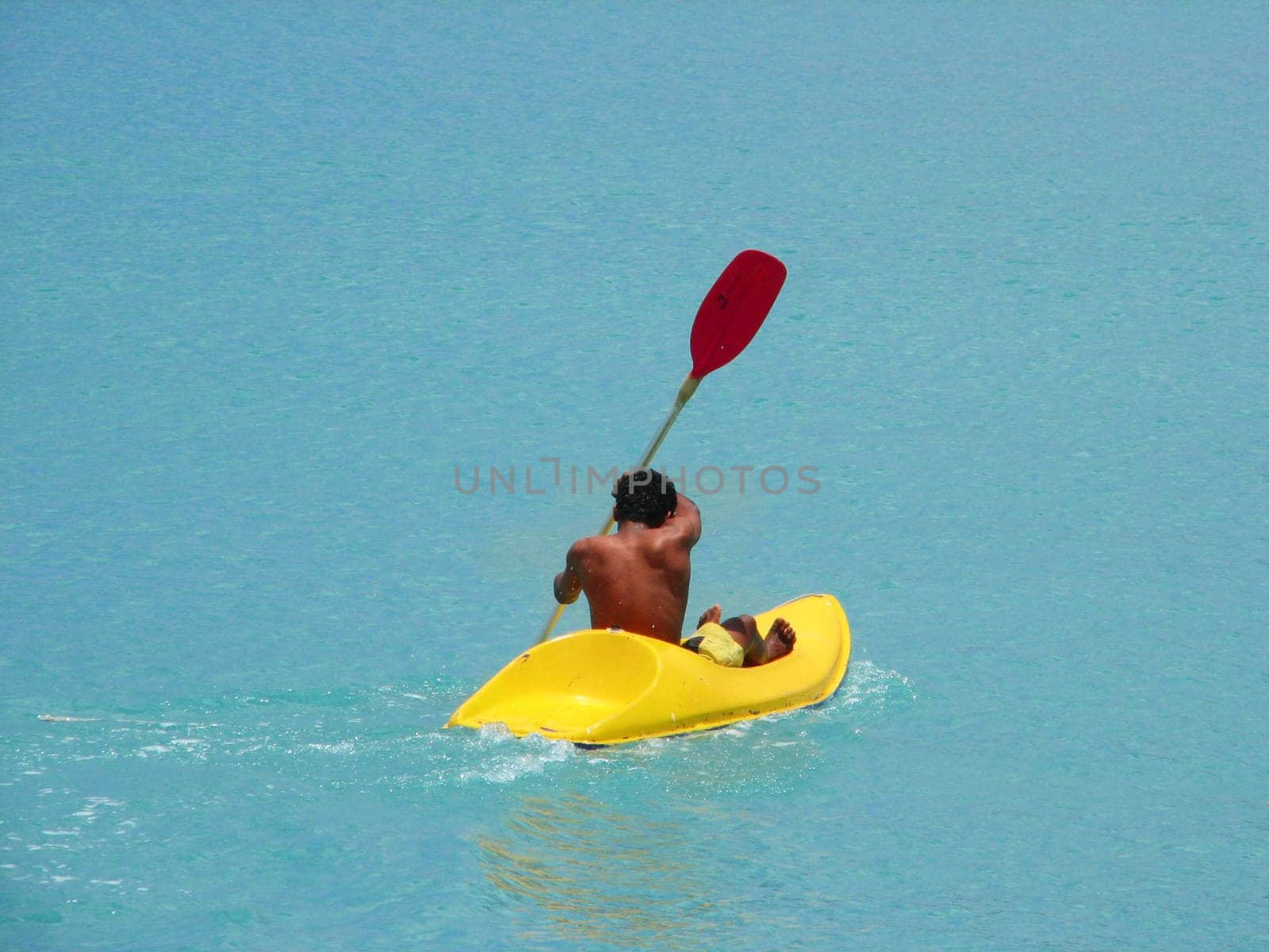 Man paddling in canoe,Mauritius