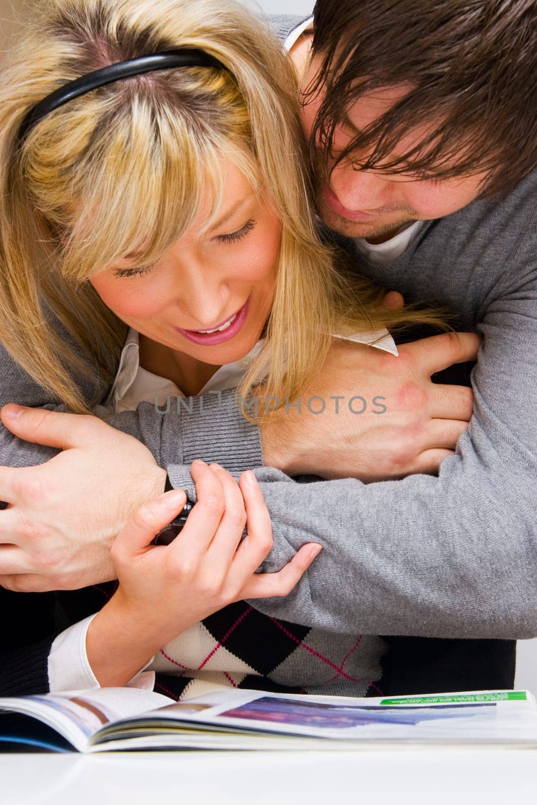 happy loving couple reading magazine