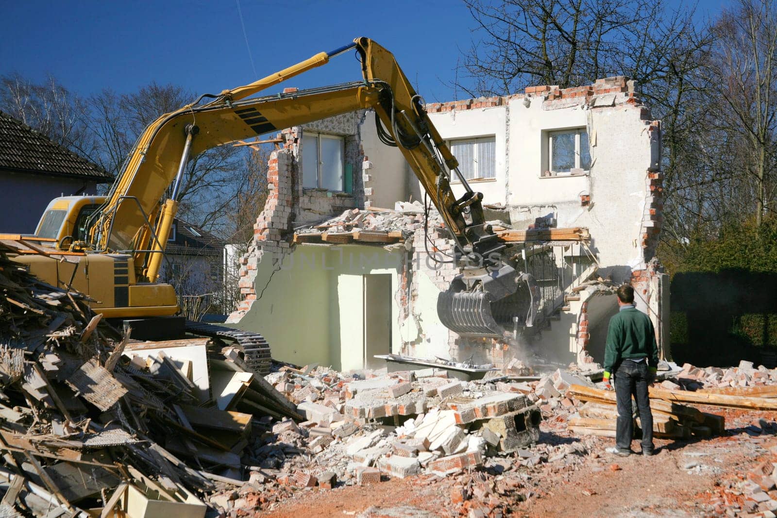 Excavator eats house