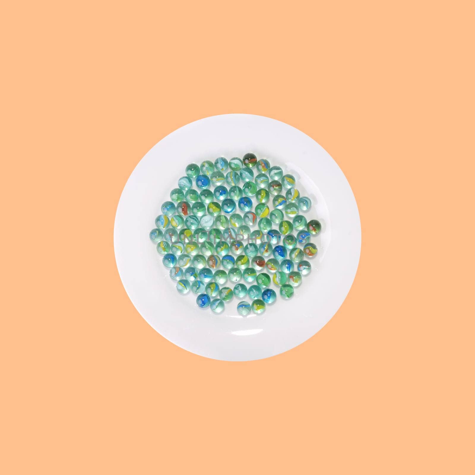 Plate of marbles in front of orange