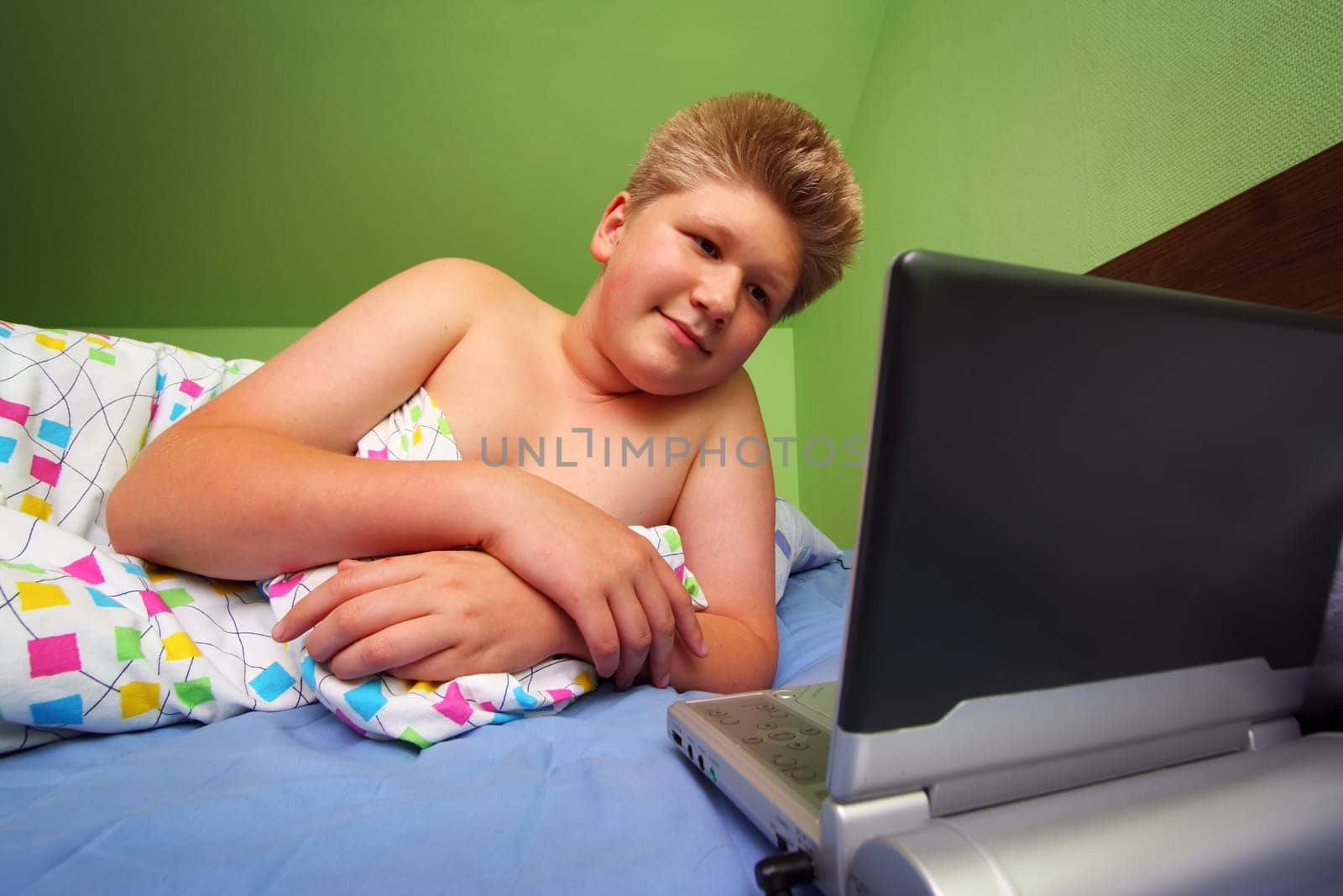 Teenager watching portable DVD player