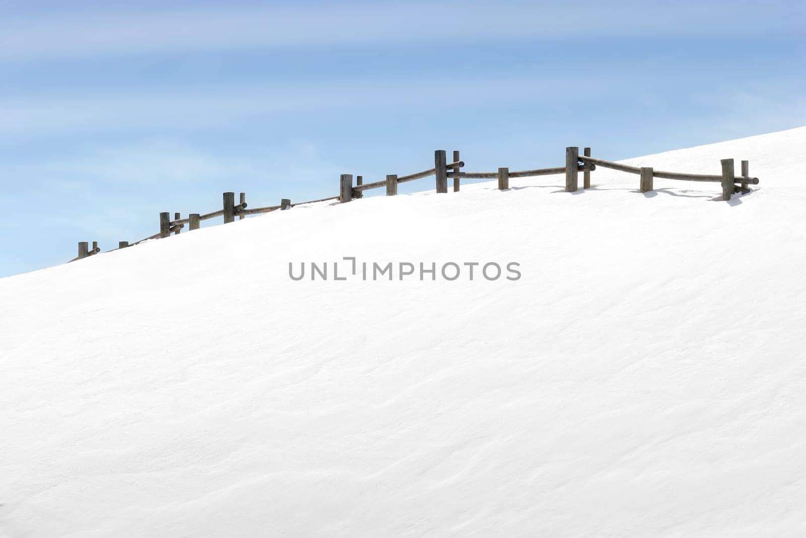 fence on snowy hill