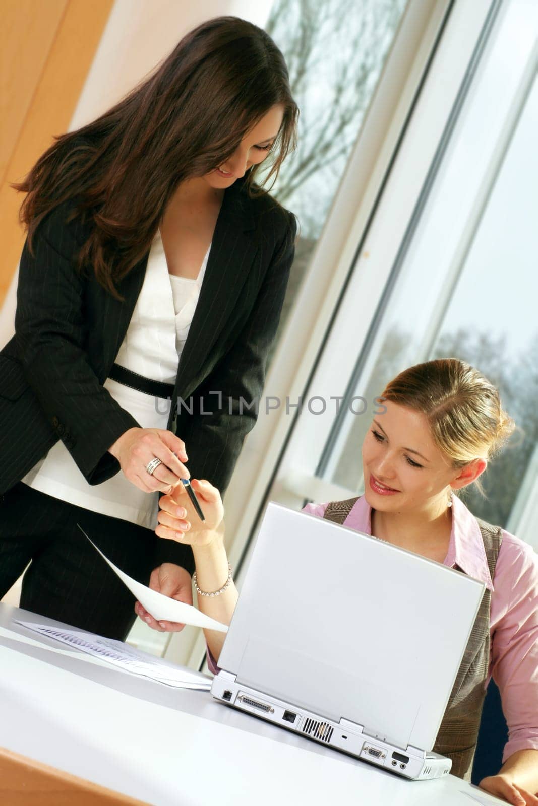 Businesswoman on computer with secretary