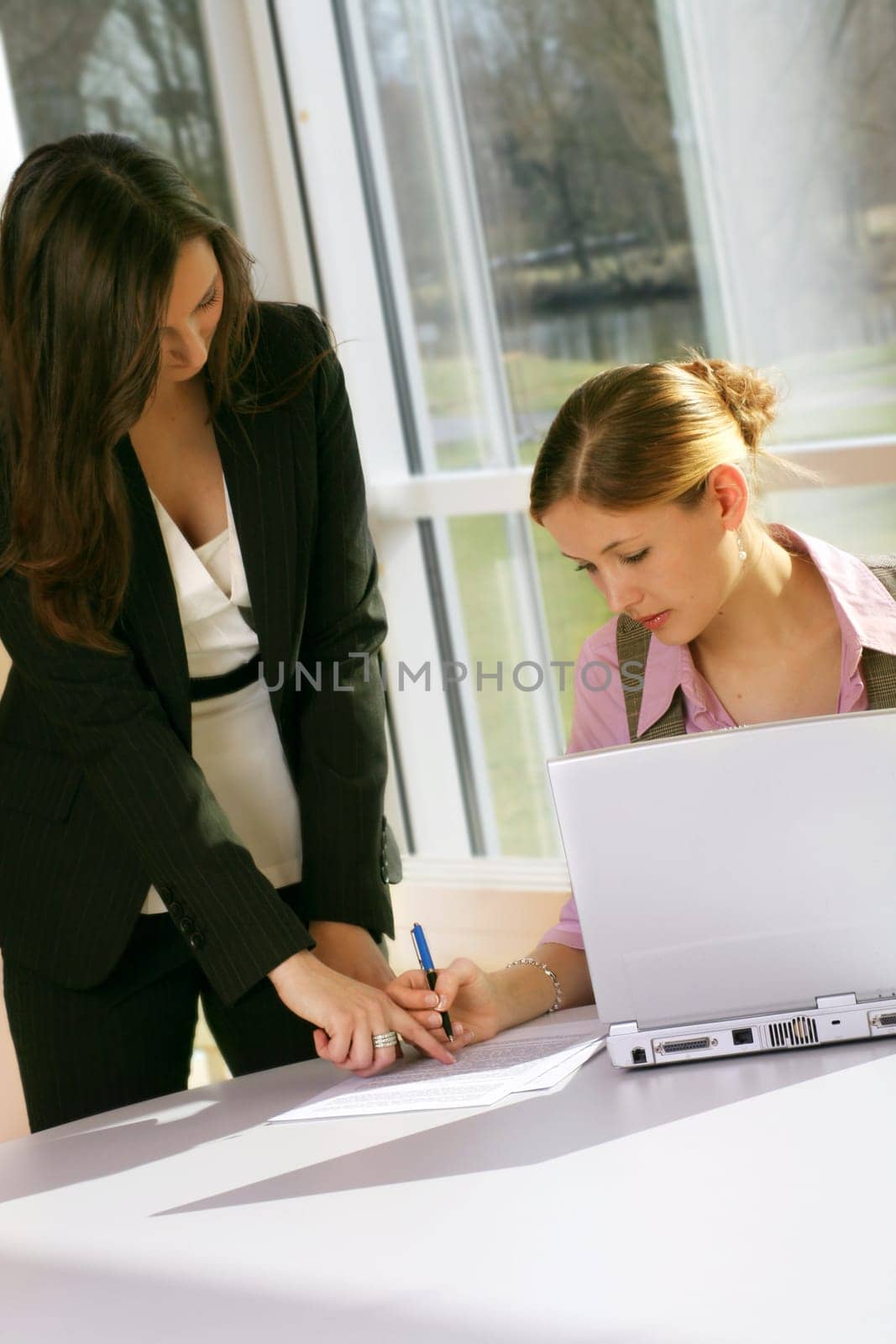 Businesswoman on computer with secretary