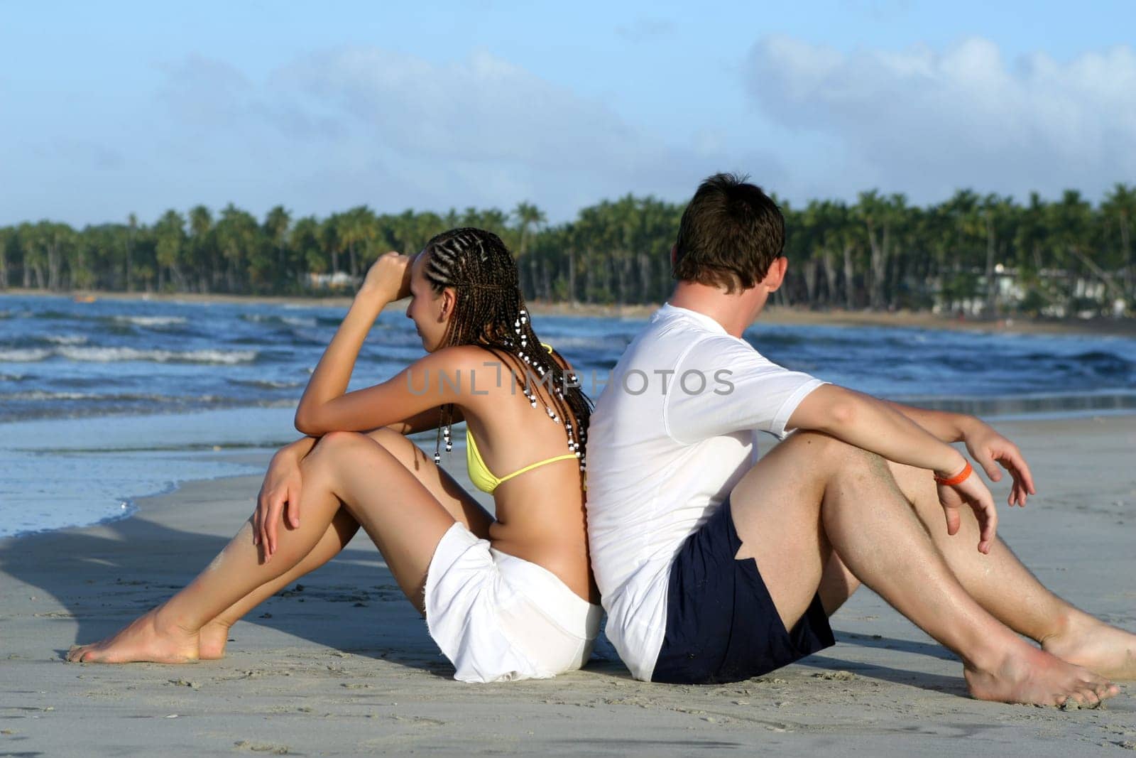 Couple sitting back to back