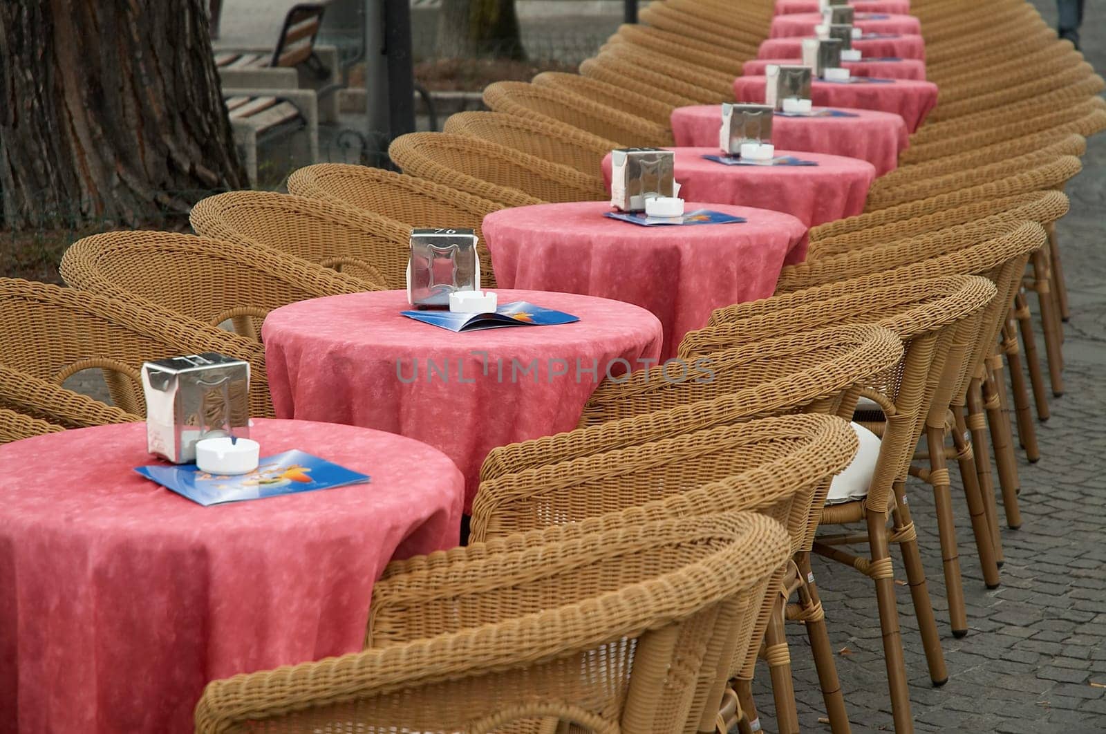 Empty tables and armchairs outdoors