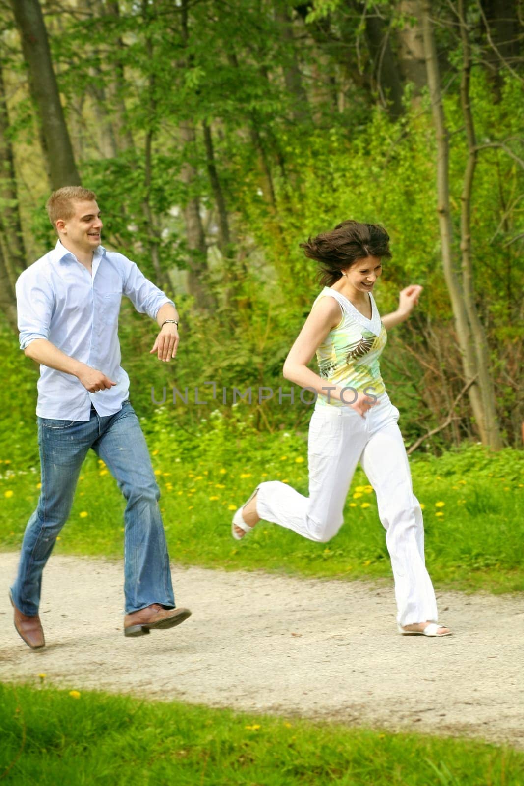 Happy couple in the park running