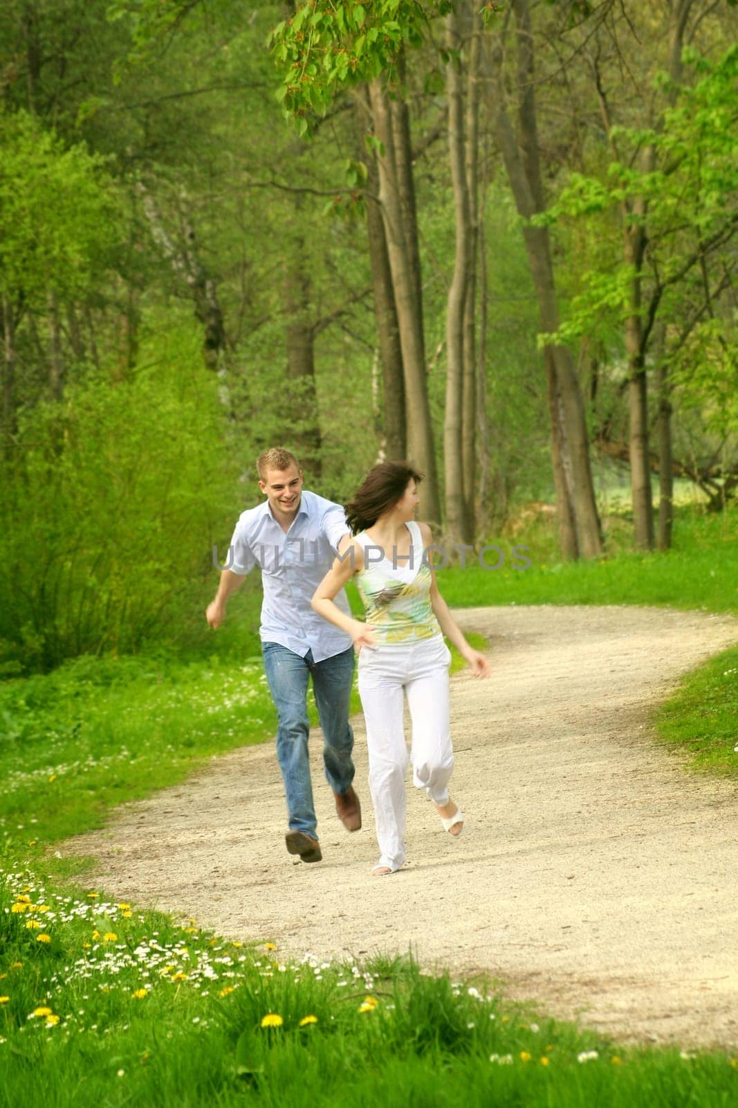 Happy couple in the park running