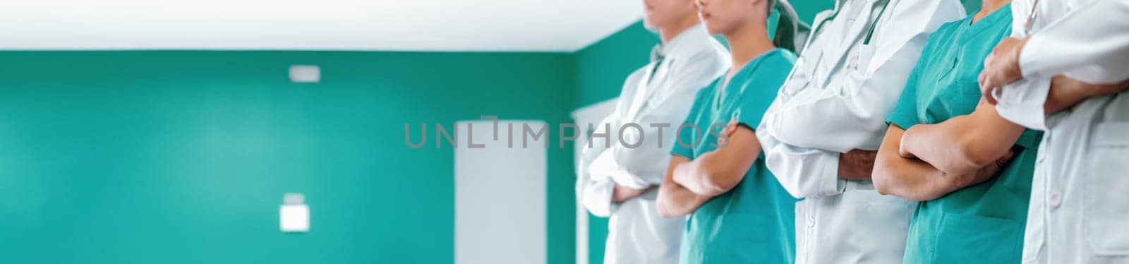 Confident medical staff team with doctor nurse and healthcare specialist professions people in hospital or clinic corridor. Medical and healthcare community in panoramic banner. Neoteric