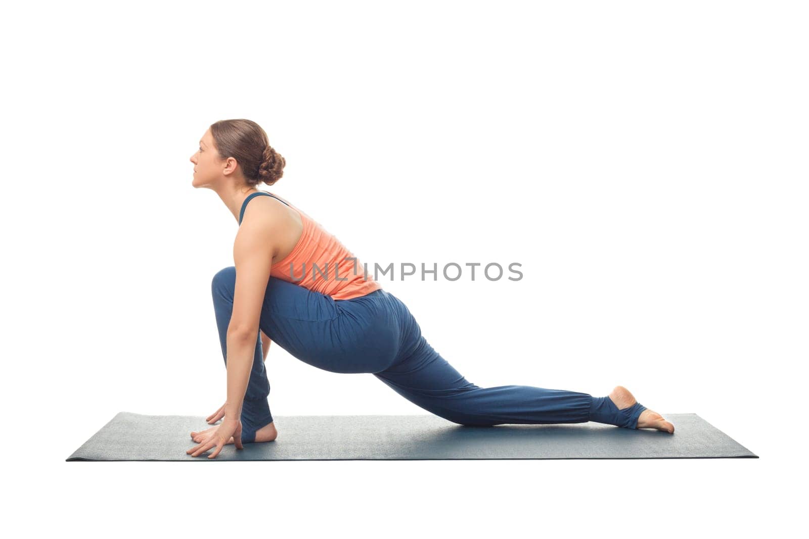 Beautiful sporty fit yogini woman practices yoga asana Anjaneyasana - low crescent lunge pose in surya namaskar isolated on white