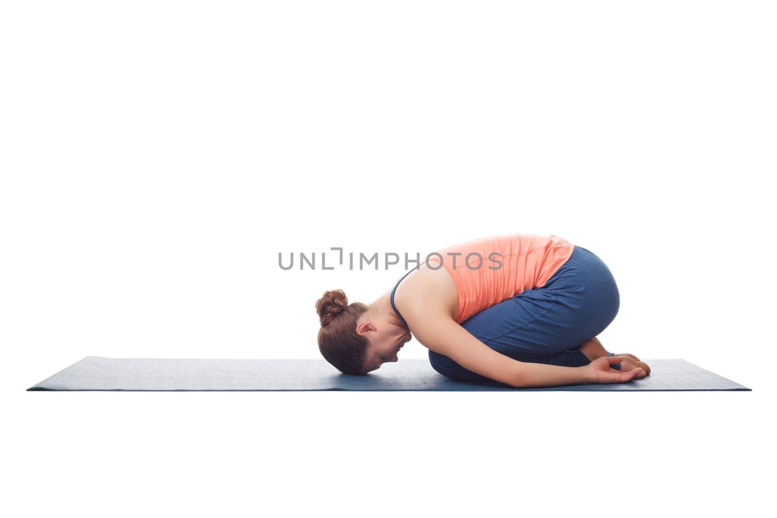 Beautiful sporty fit yogini woman practices yoga asana balasana (child's pose) - resting pose or counter asana for many asanas isolated on white