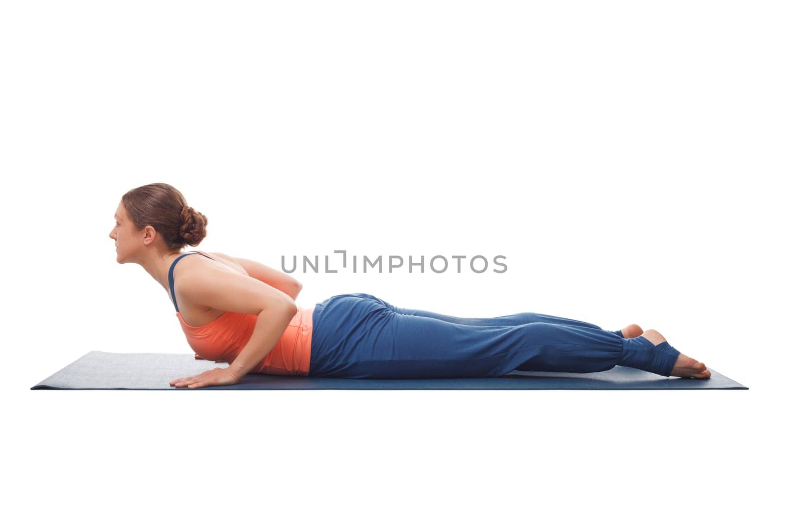 Beautiful sporty fit yogini woman practices yoga asana bhujangasana - cobra pose beginner variation isolated on white background