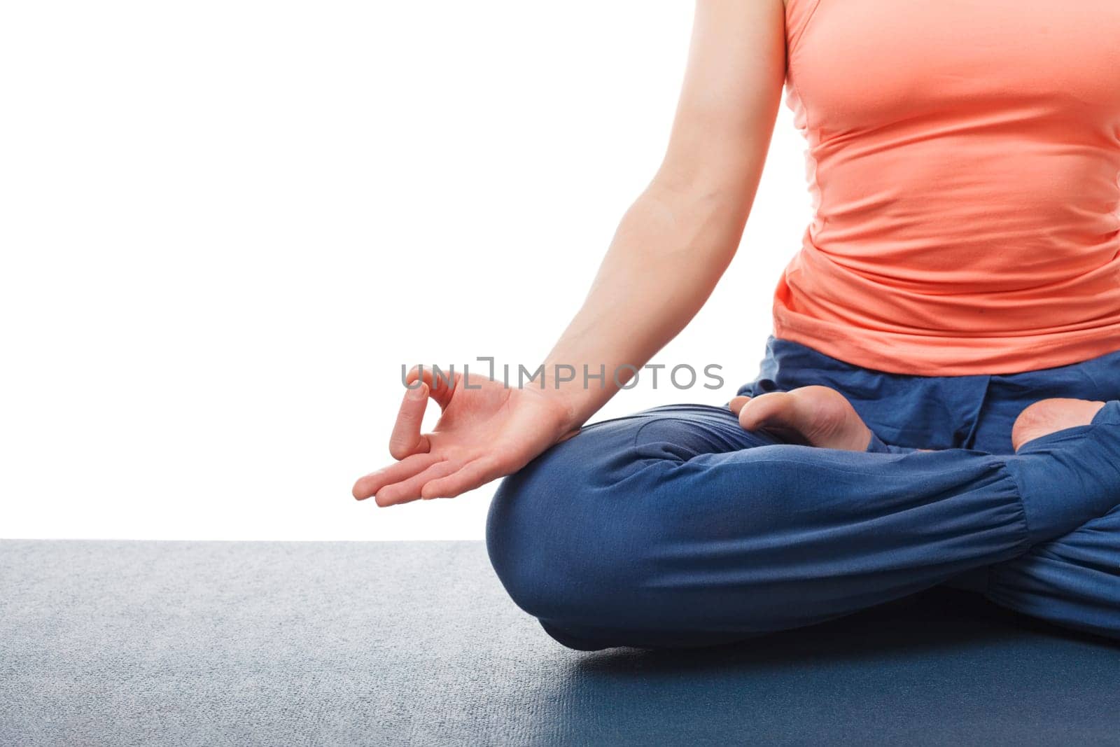 Close-up of yogini woman in yoga asana Padmasana (Lotus pose) cross legged position for meditation with Chin Mudra (psychic gesture of consciousness). Isolated on white background with copyspace