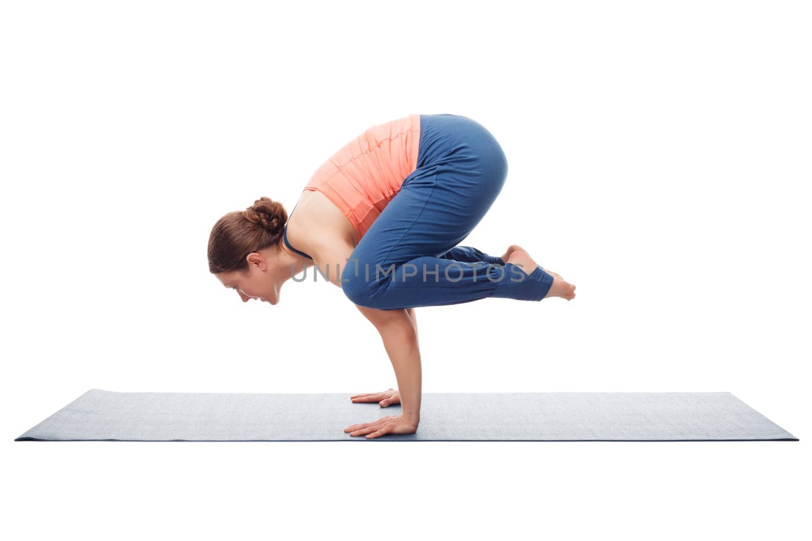 Beautiful sporty fit yogini woman practices yoga asana kakasana - crow pose isolated on white