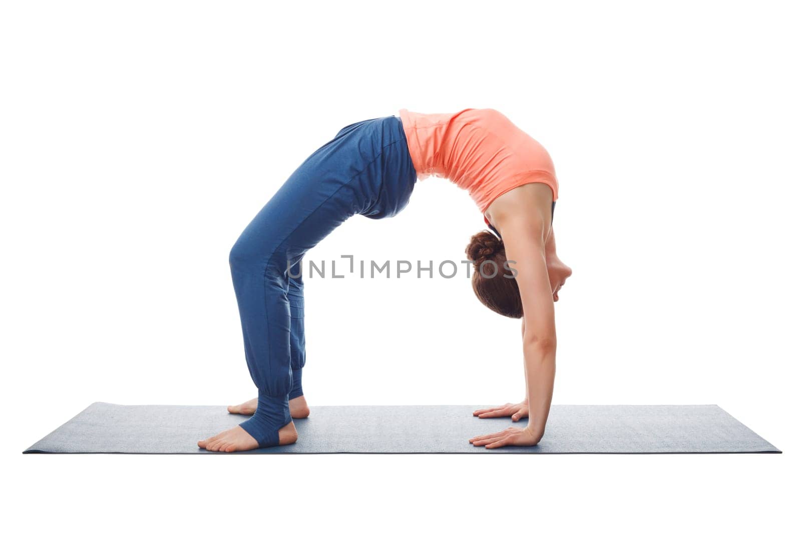 Beautiful sporty fit yogini woman practices yoga asana chakrasana (or urdva dhanurasana) - wheel pose (or upward facing bow) pose isolated on white