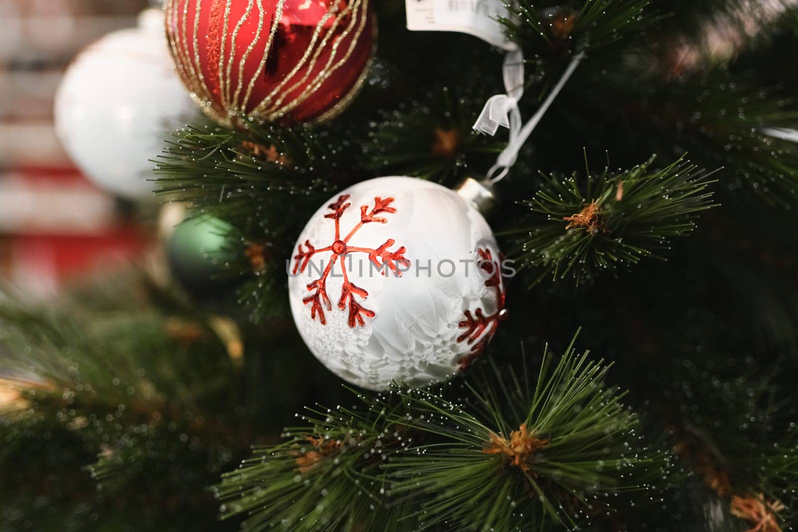 White and red christmas decorations balls for the Christmas tree are sold in the store