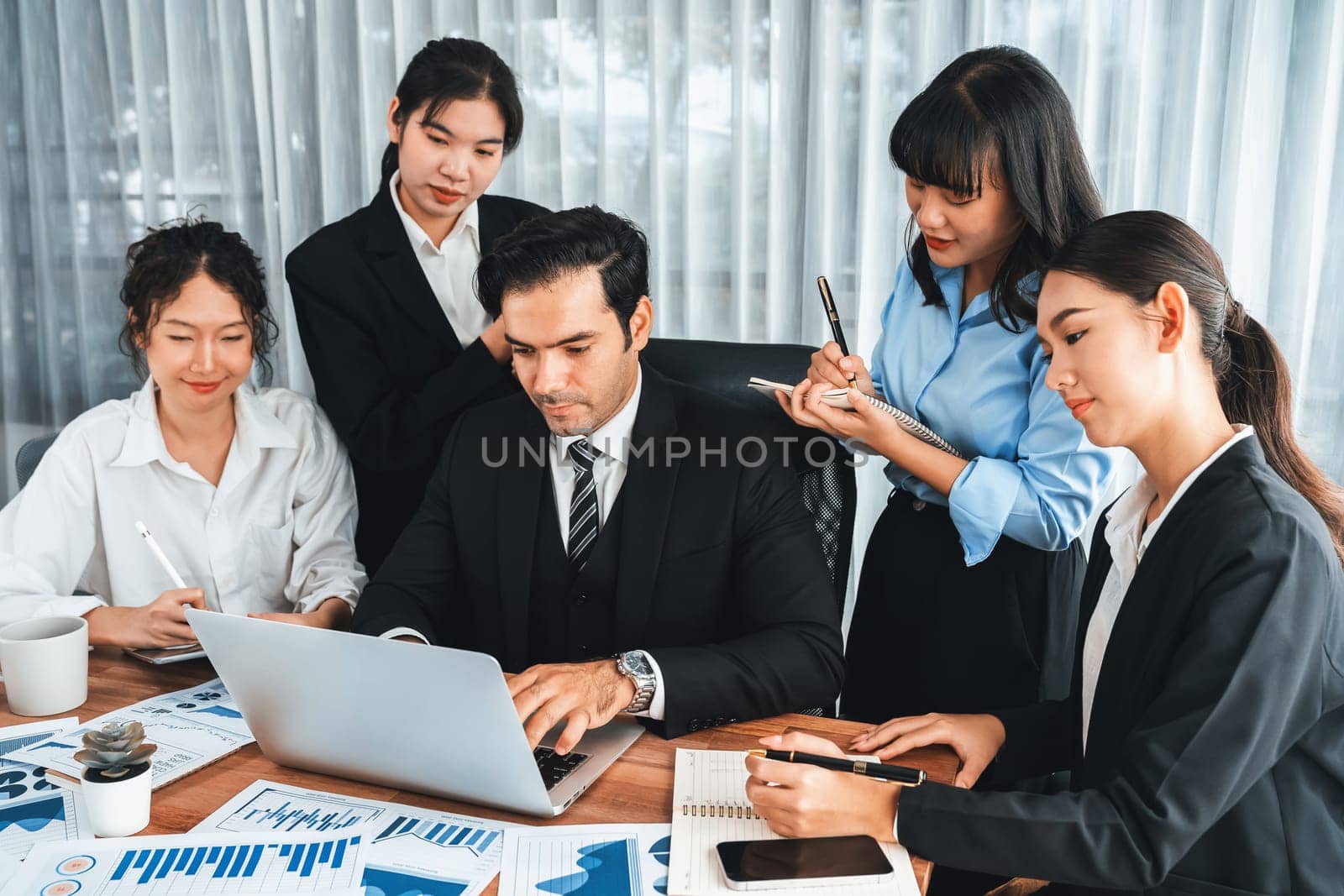 Diverse group of business analyst team analyzing financial data report paper on office table. Chart and graph dashboard by business intelligence analysis for strategic marketing planning Meticulous