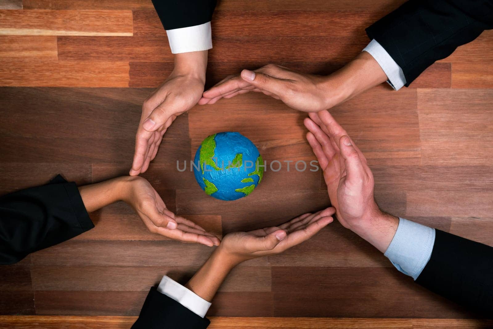 Top view business people holding Earth together in synergy as team building to utilize eco regulation for environmental protection by reducing CO2 emission to save Earth. Quaint