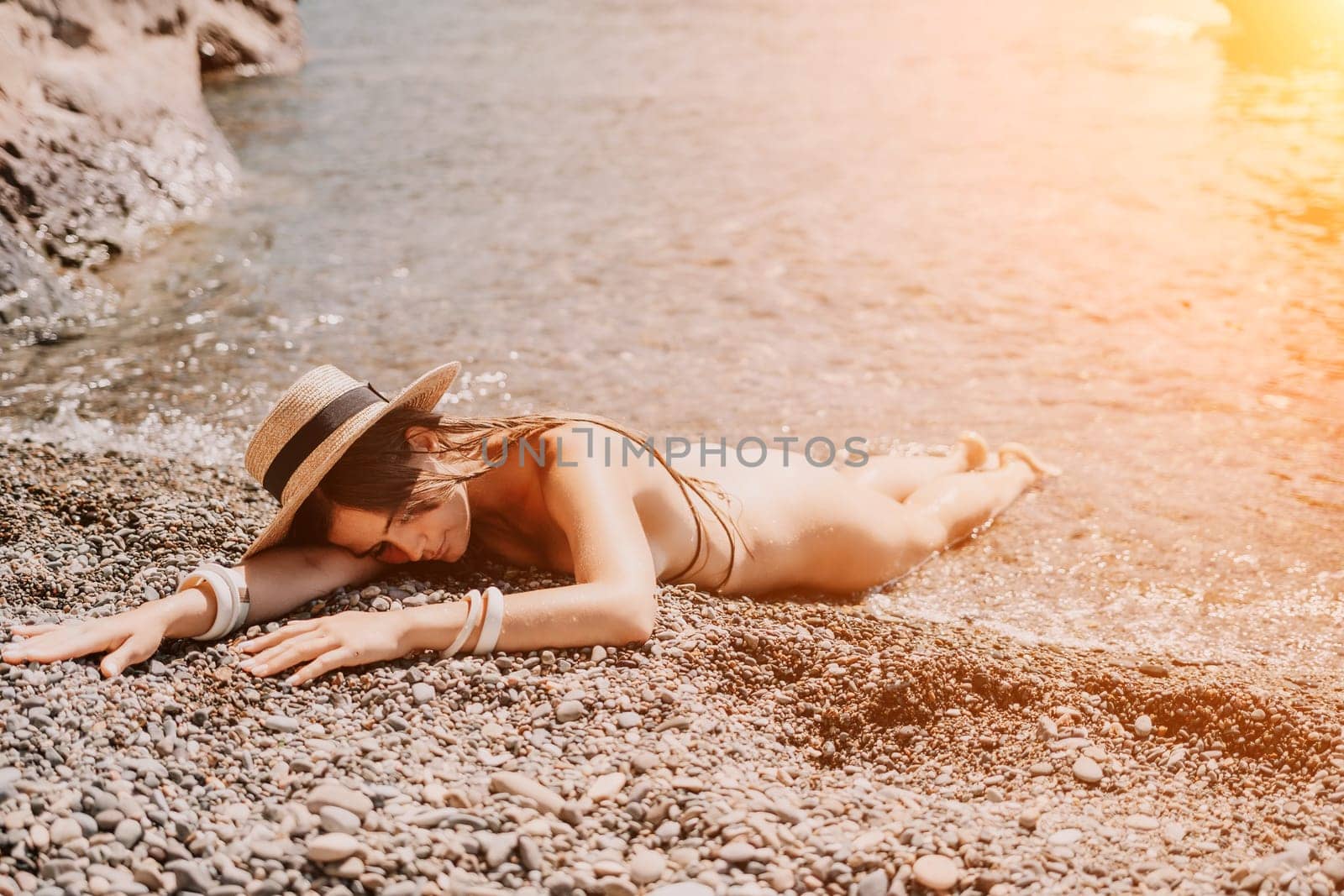 Woman travel sea. Happy tourist taking picture outdoors for memories. Woman traveler looks at the edge of the cliff on the sea bay of mountains, sharing travel adventure journey.