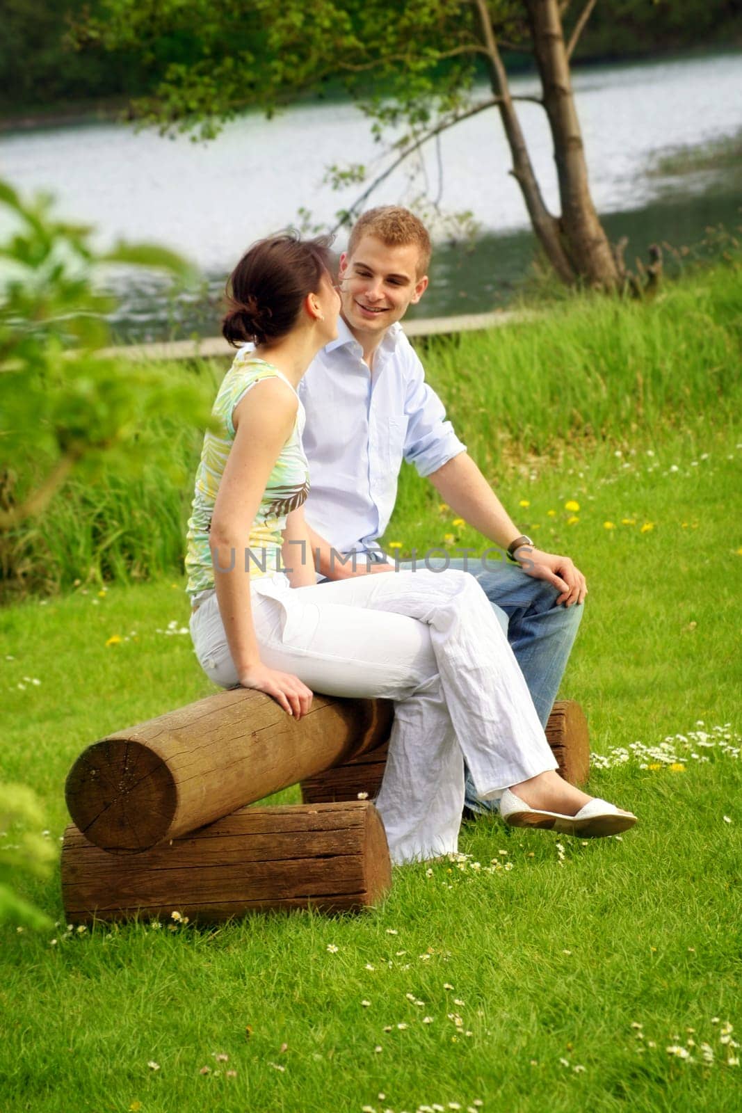 Happy couple in park by lake