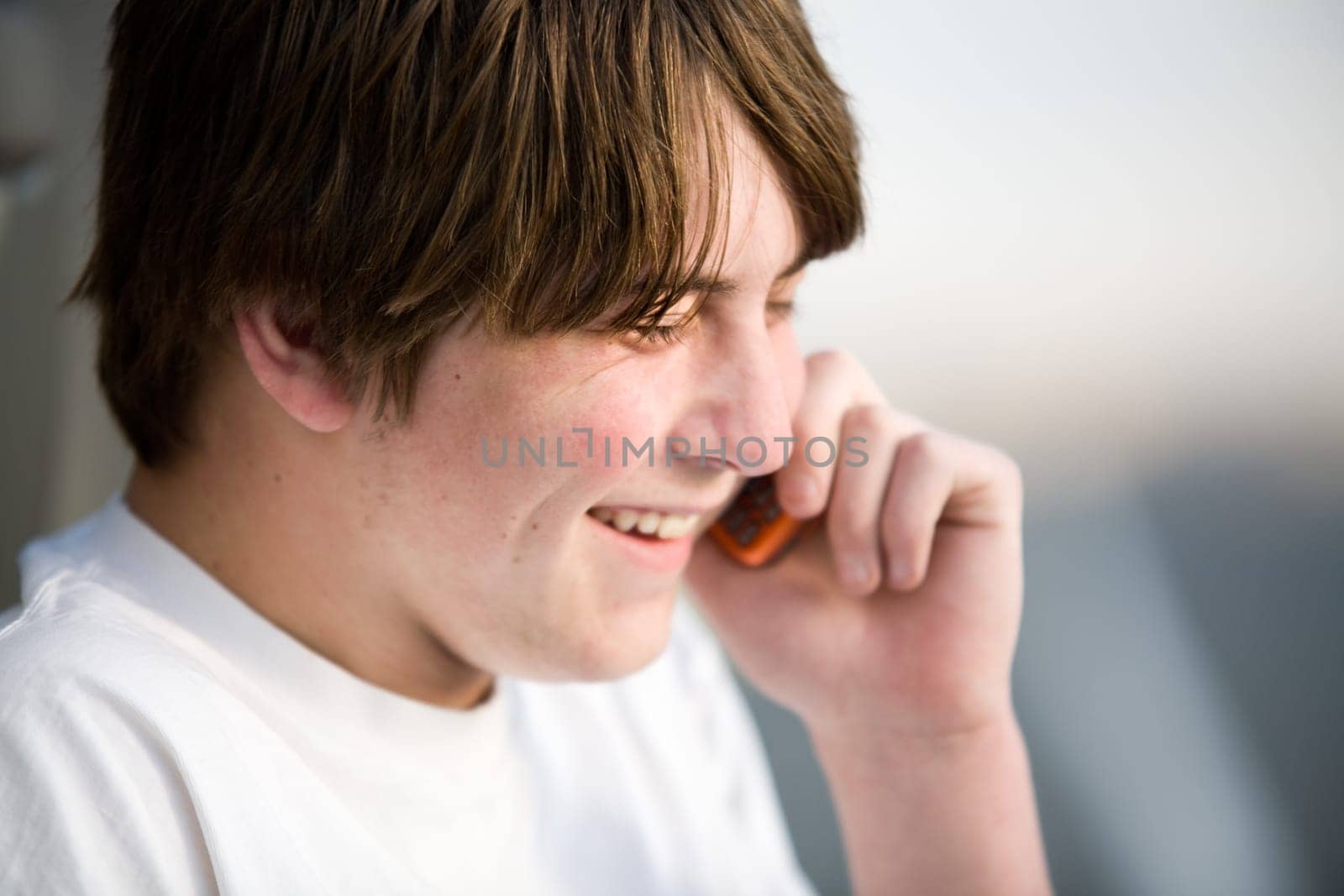 teenager on cellphone laughing