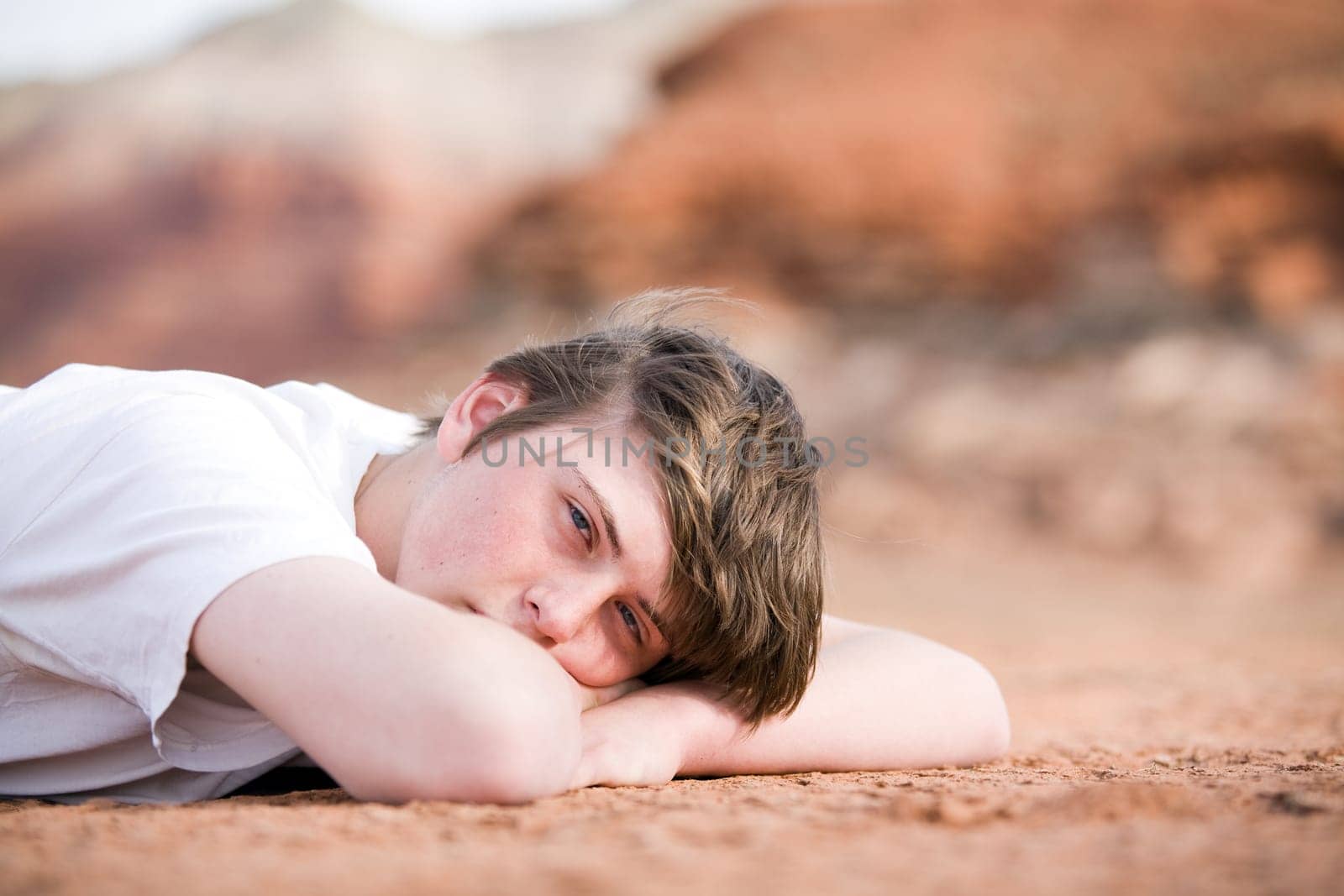 male teenager laying on ground