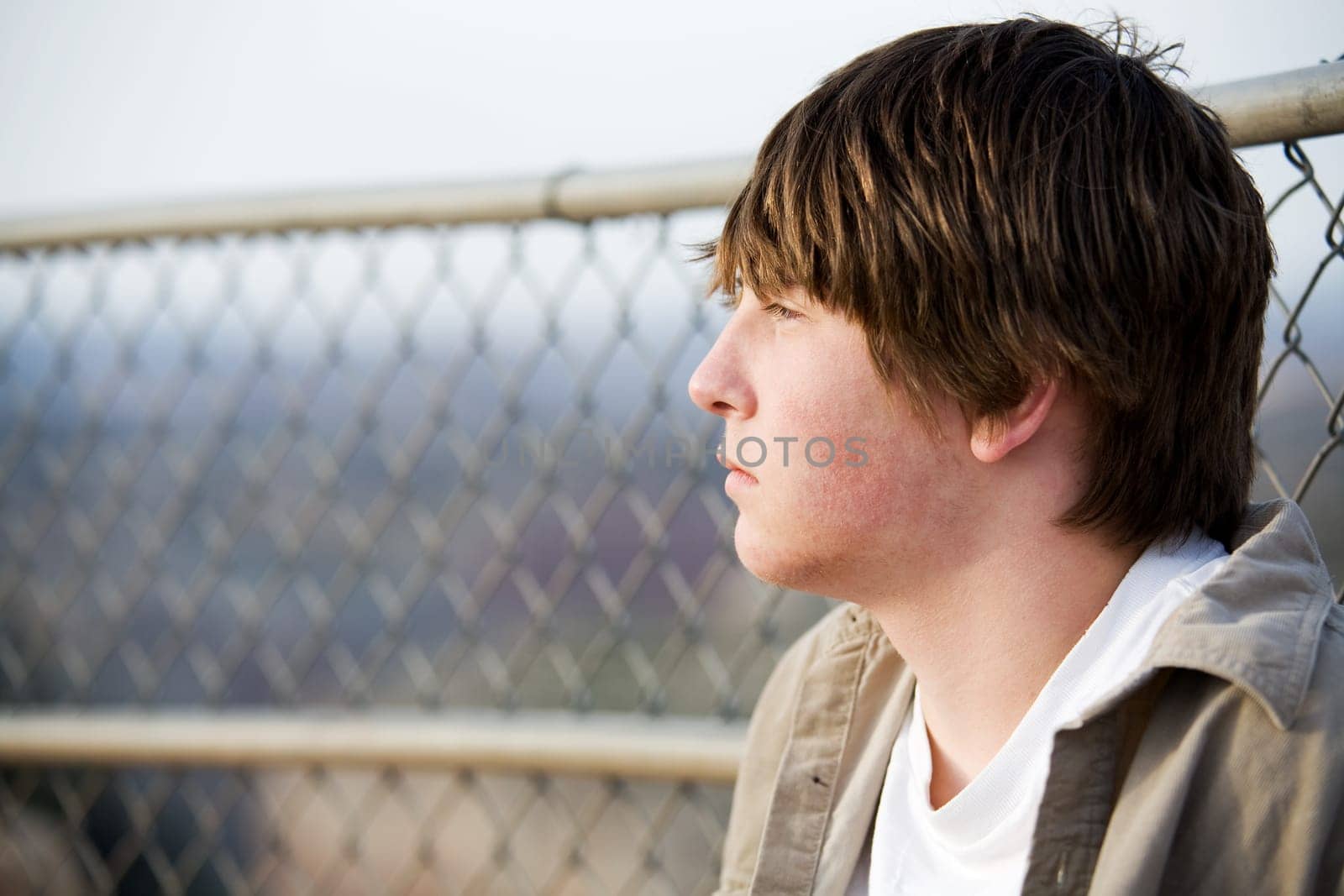 teen portrait against fence
