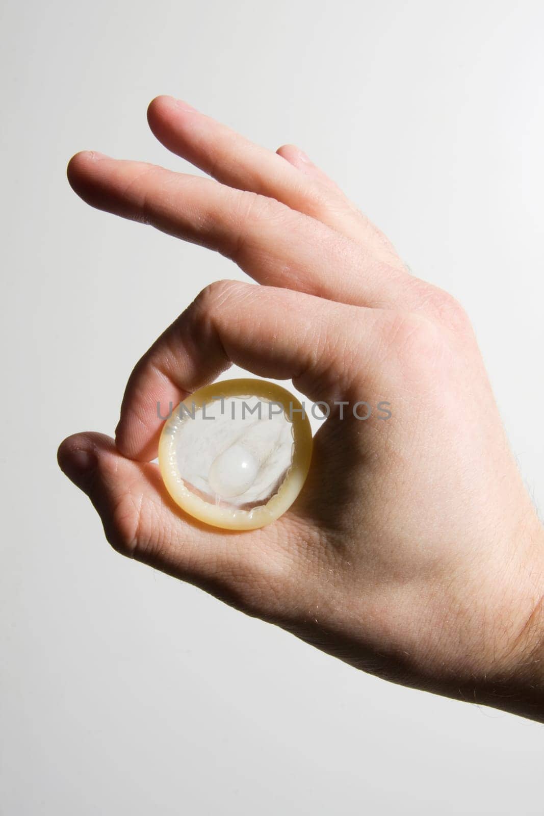 hand holding condom