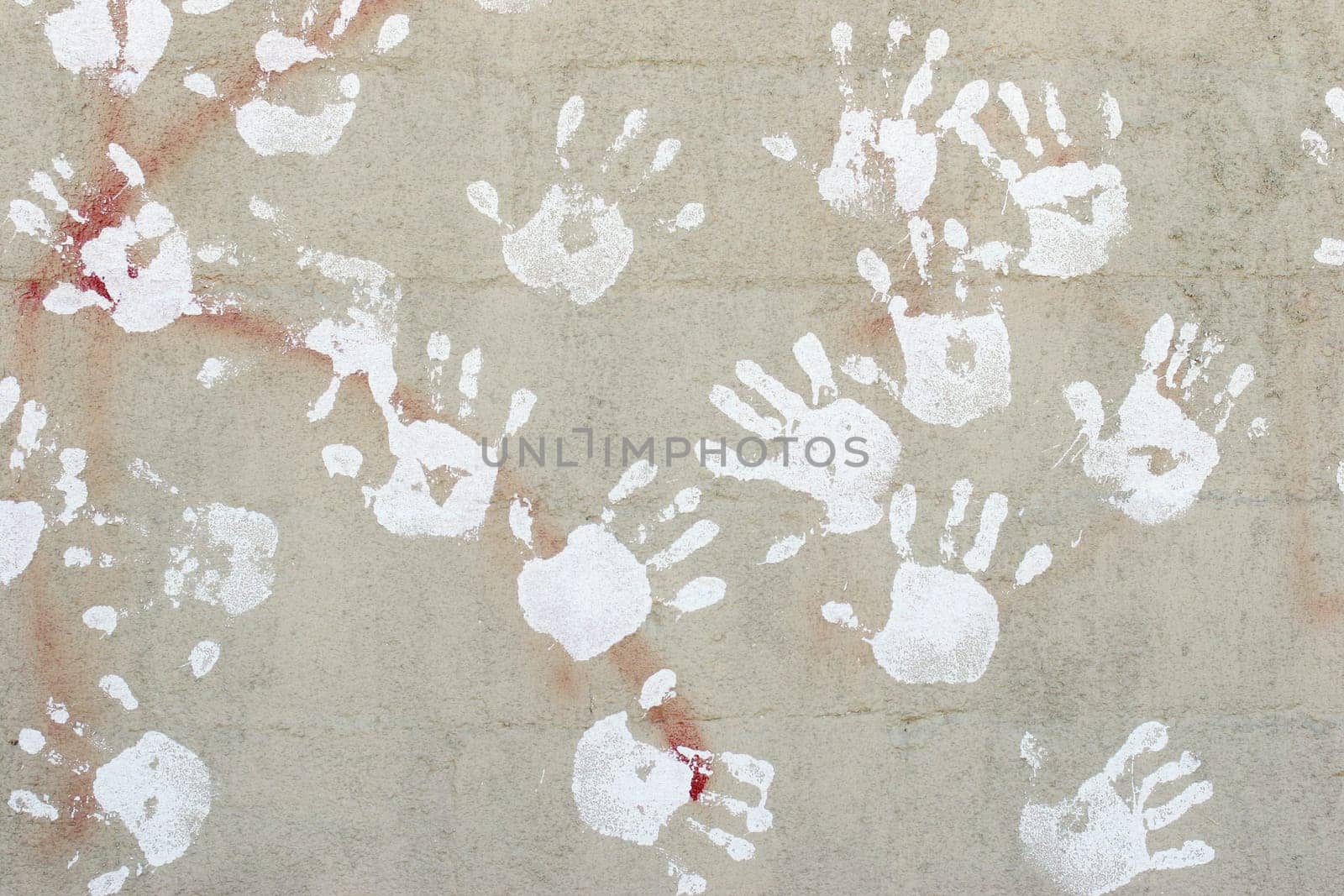 handprints on cement wall