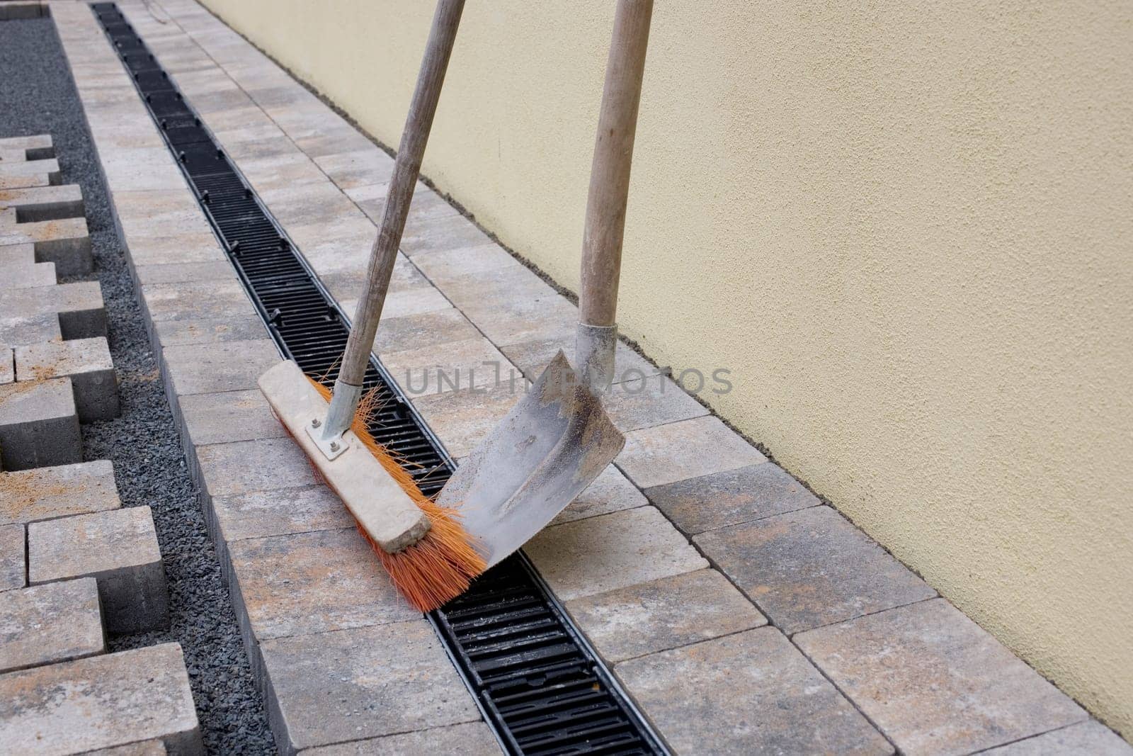 Shovel and broom on new pavement