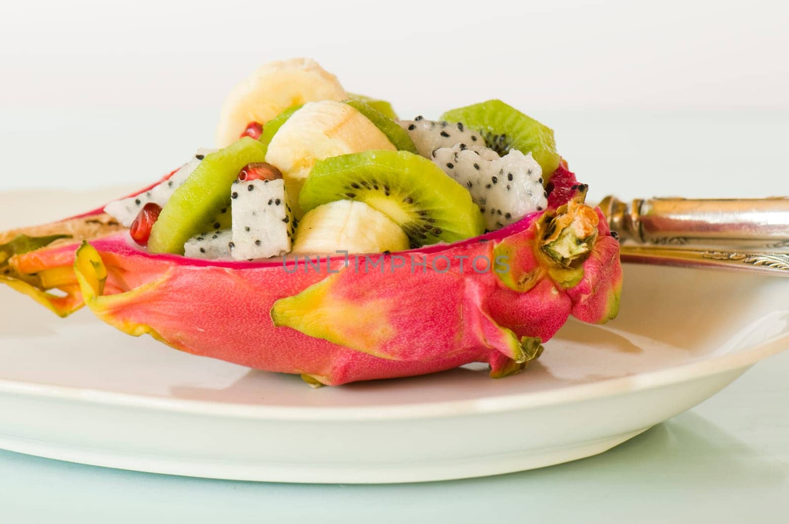 halved pitahaya with fruit salad