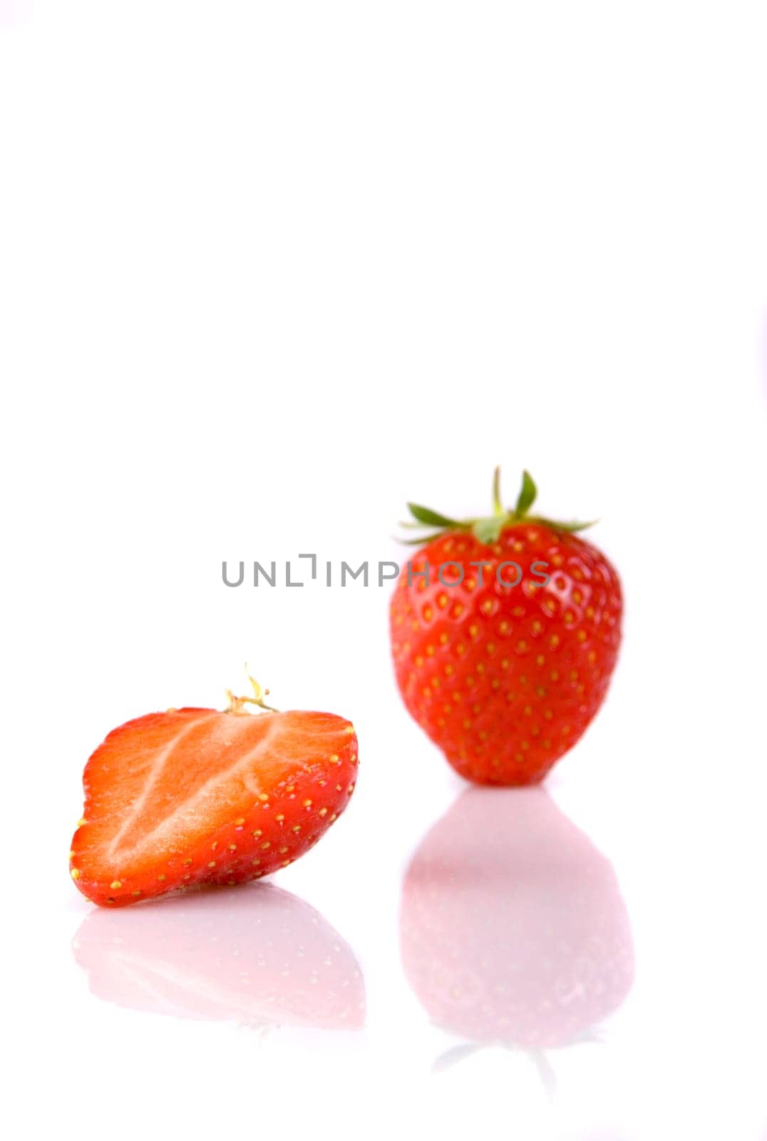 Full and half of a strawberry