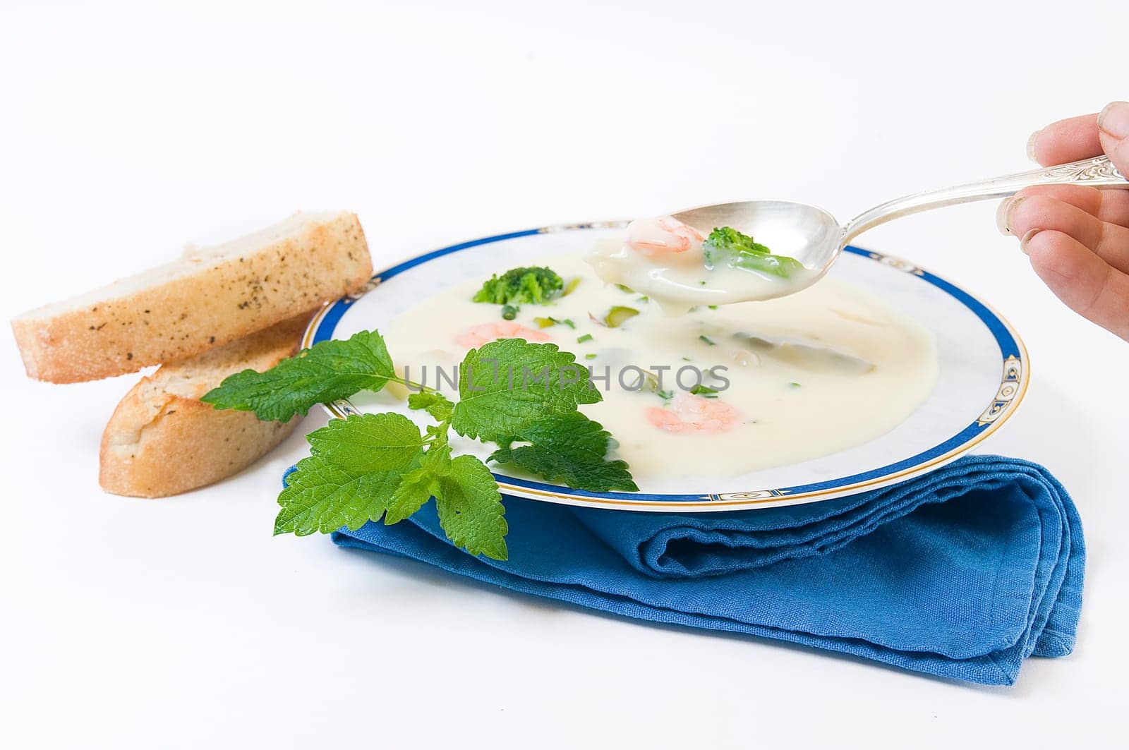 Cream of asparagus soup with broccoli and prawns