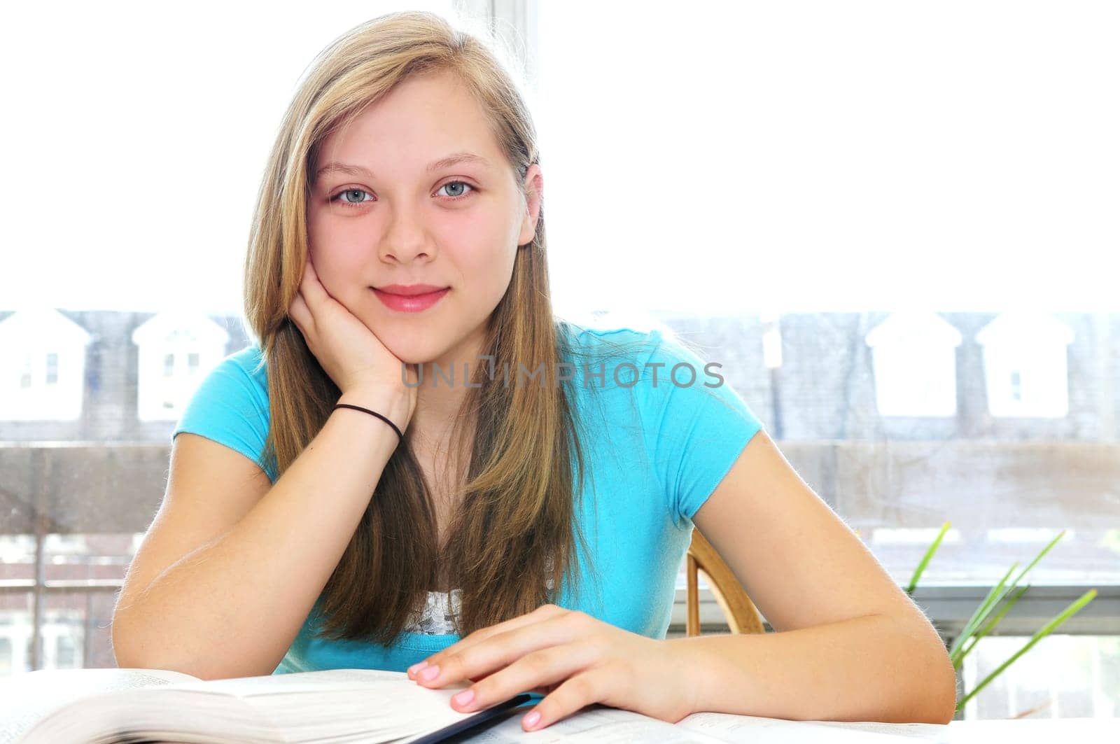 Happy teenage girl studying