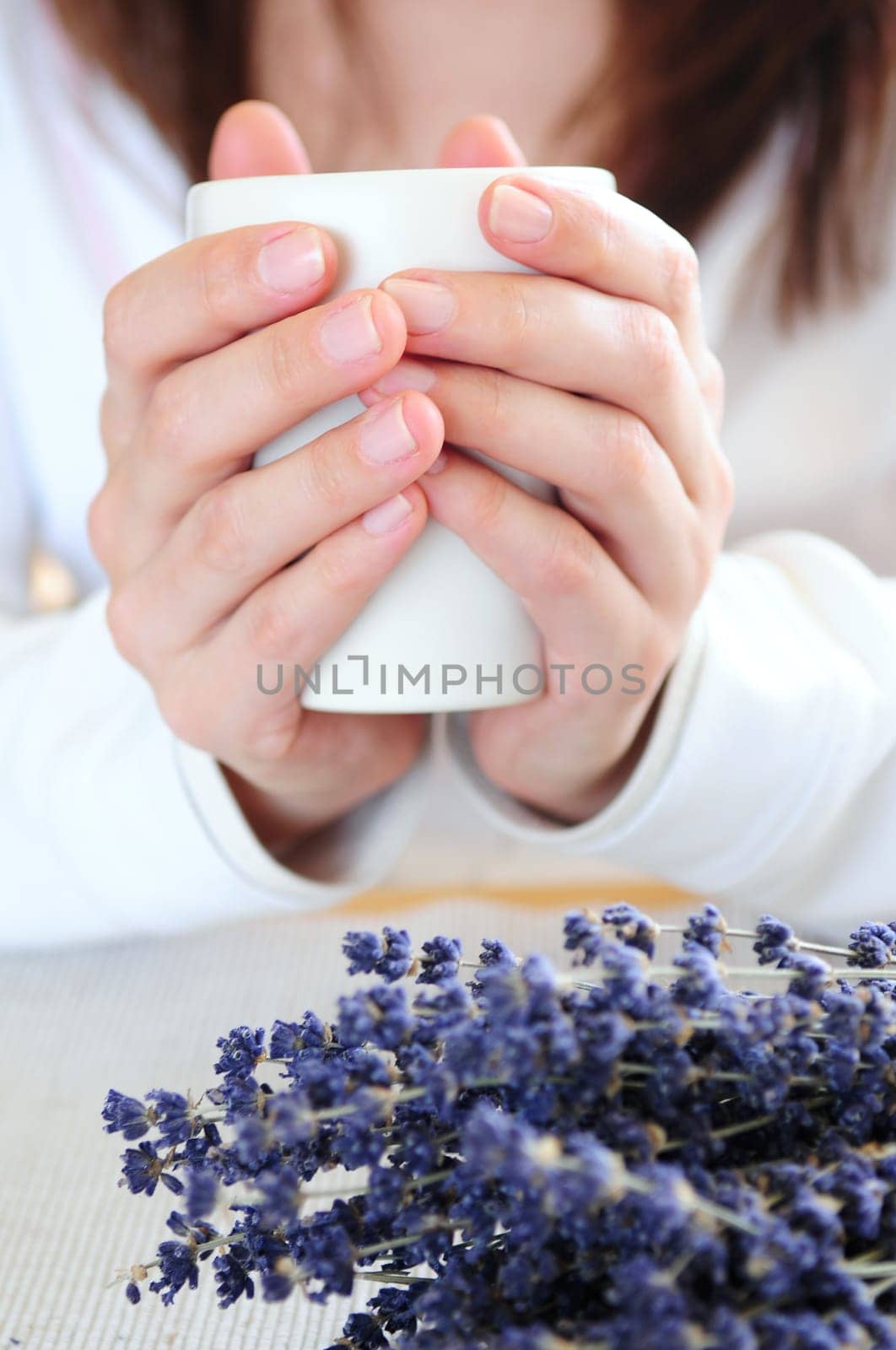 Hands holding a cup