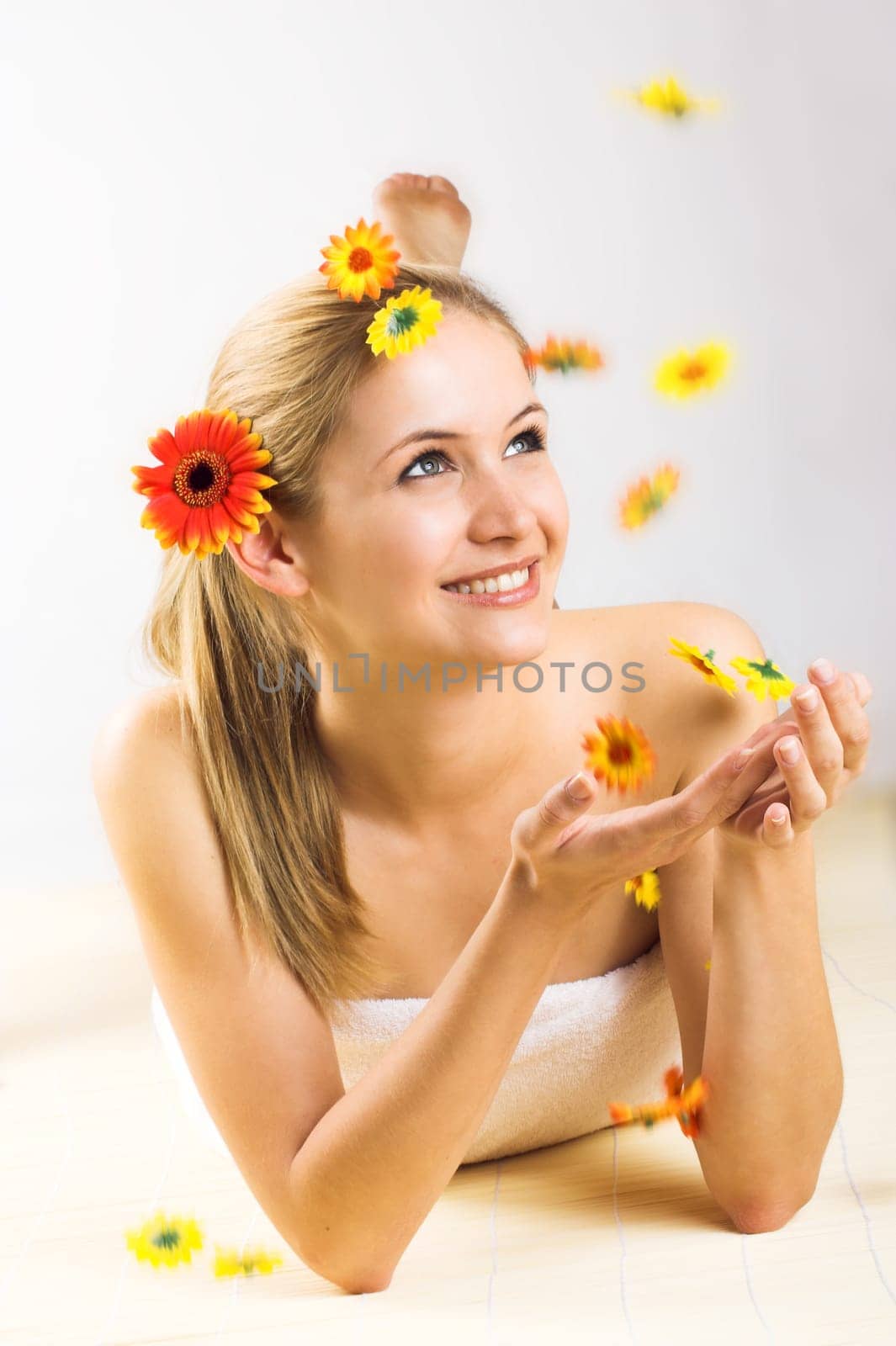 Young woman with falling flowers