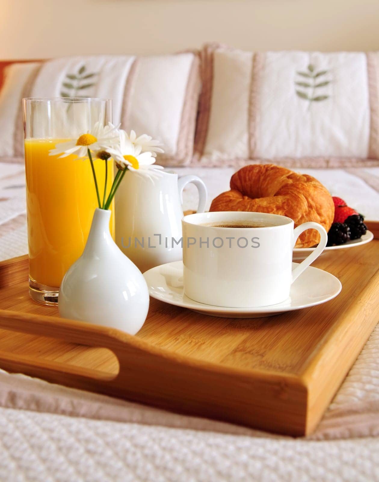 Breakfast on a bed in a hotel room