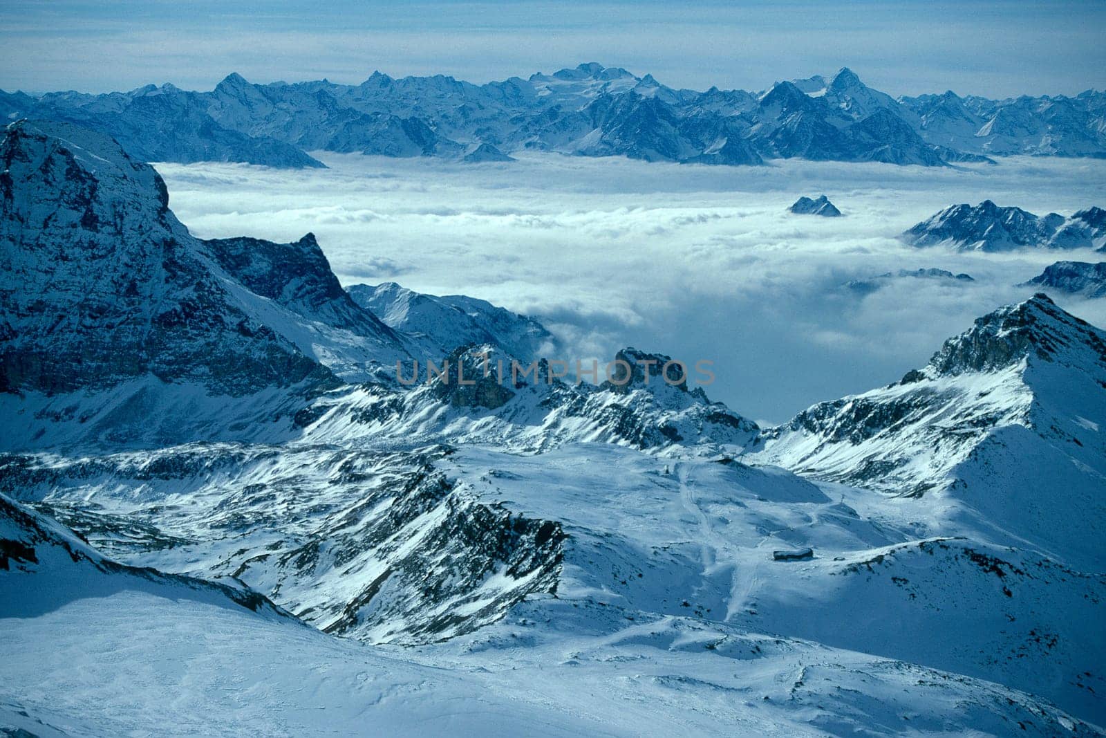 Mountains,view of the Rhône Valley with extreme visibility Valais Alps,mist-covered valley,winter