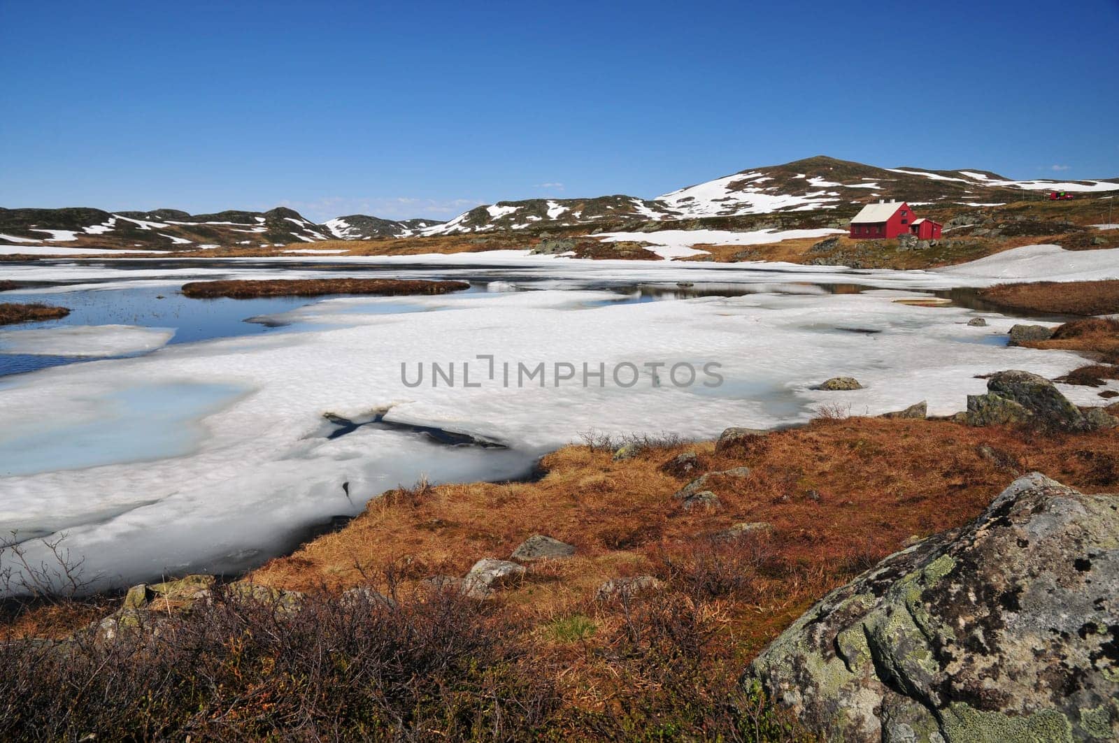 Thawing lake in June in the Hardangervidda plateau in Norway. ( 1300 meters )