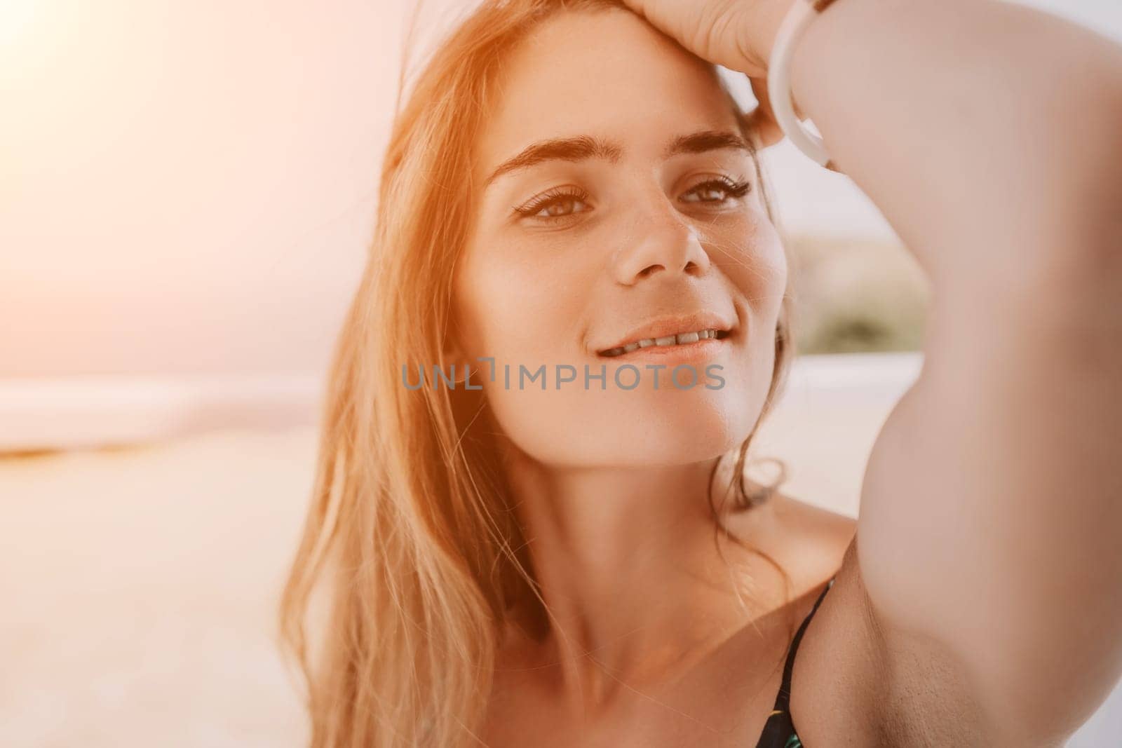 Happy woman portrait in cafe. Boho chic fashion style. Outdoor photo of young happy woman with long hair, sunny weather outdoors sitting in modern cafe. by panophotograph