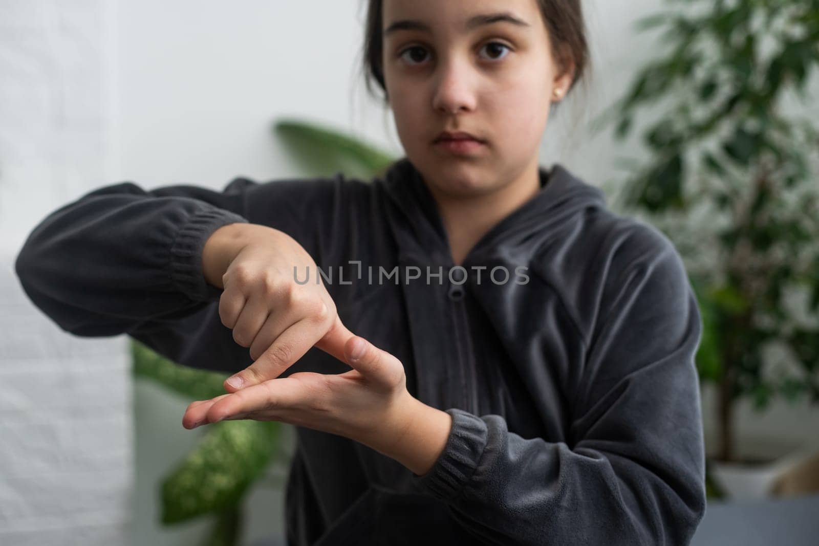 Beautiful smiling deaf girl using sign language