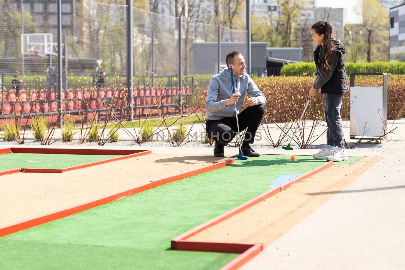 Family Time Playing Mini-Golf In The Summer.