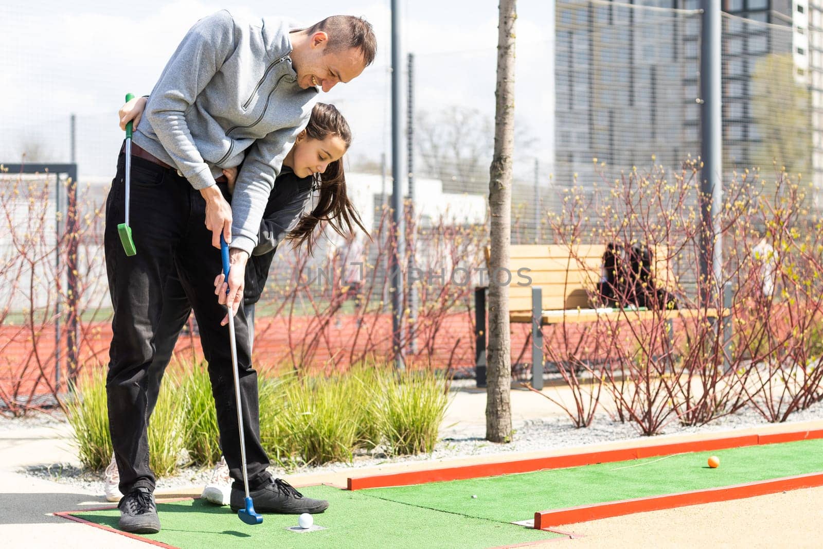 Family Time Playing Mini-Golf In The Summer.