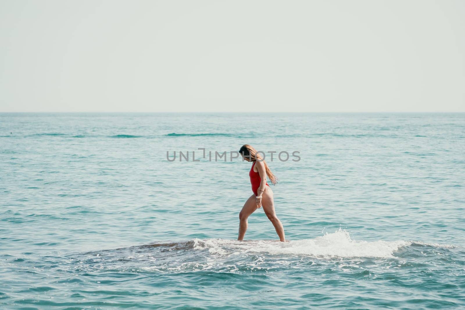 Woman sea yoga. Back view of free calm happy satisfied woman with long hair standing on top rock with yoga position against of sky by the sea. Healthy lifestyle outdoors in nature, fitness concept by panophotograph