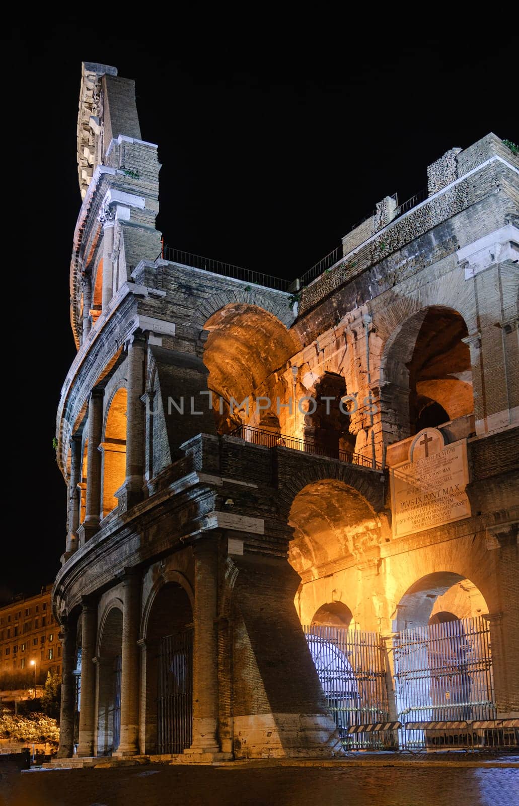Vertical view of the Colosseum in Rome illuminated at night
