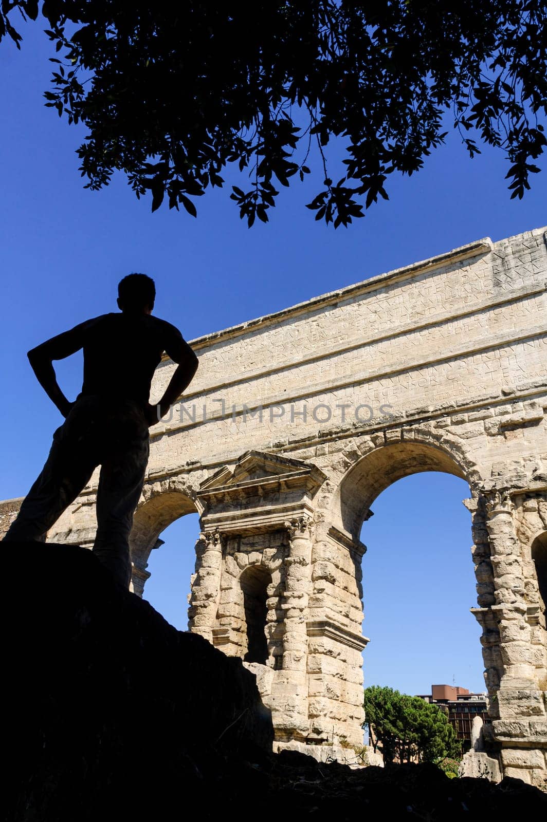 Traveler admiring the Porta Maggiore, in Rome by ivanmoreno