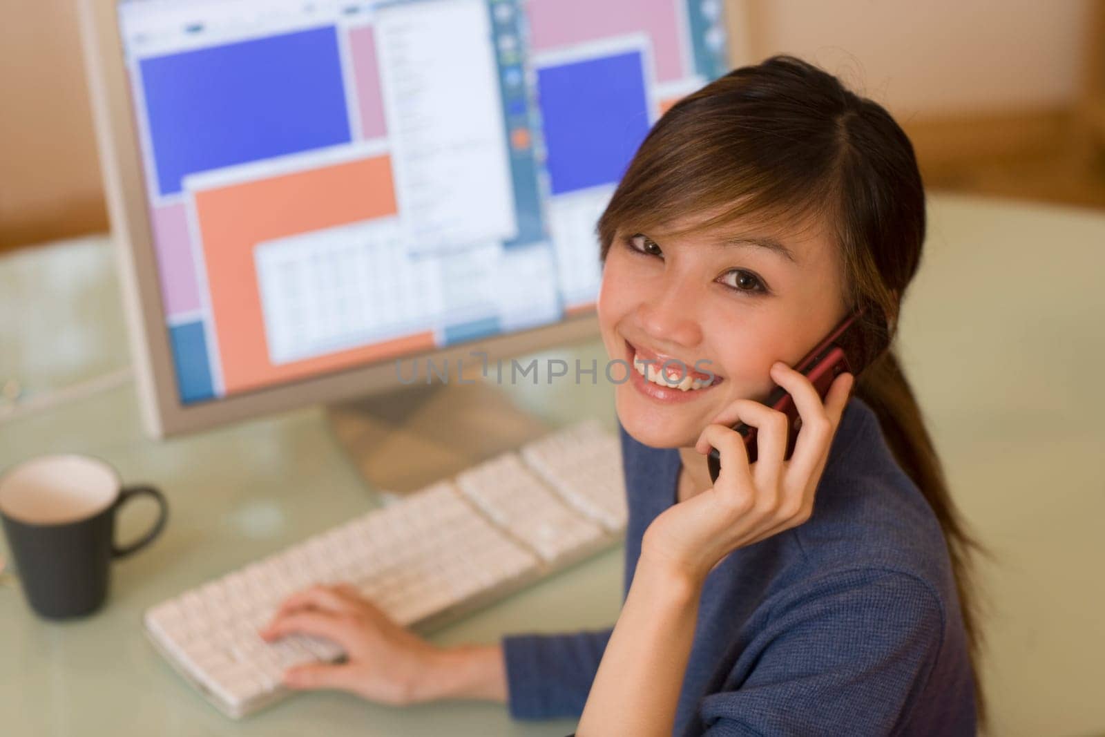 Smiling woman using computer
