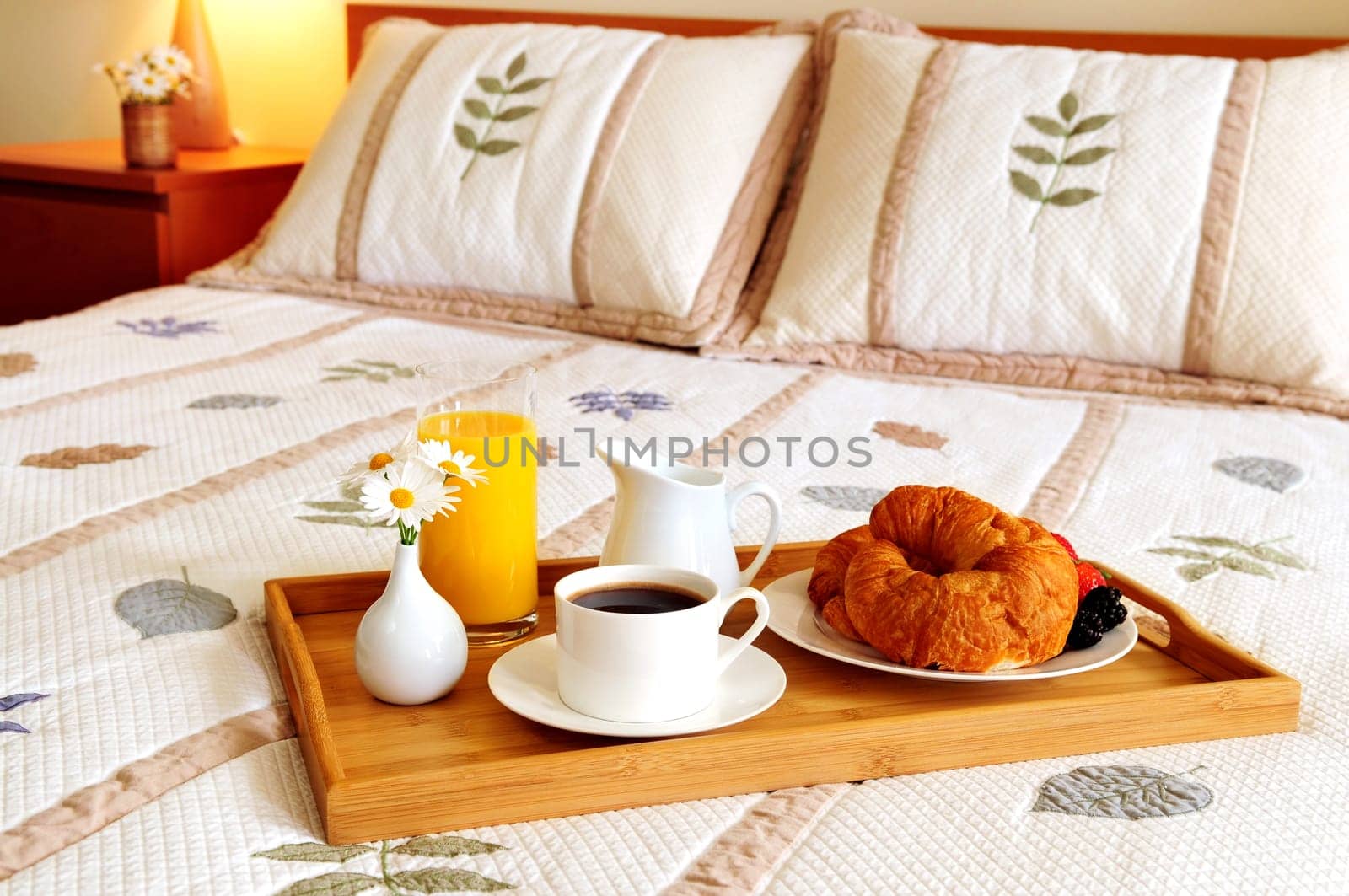Breakfast on a bed in a hotel room