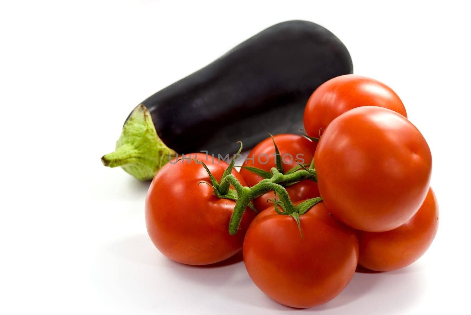 Vine tomatoes and aubergine - on white